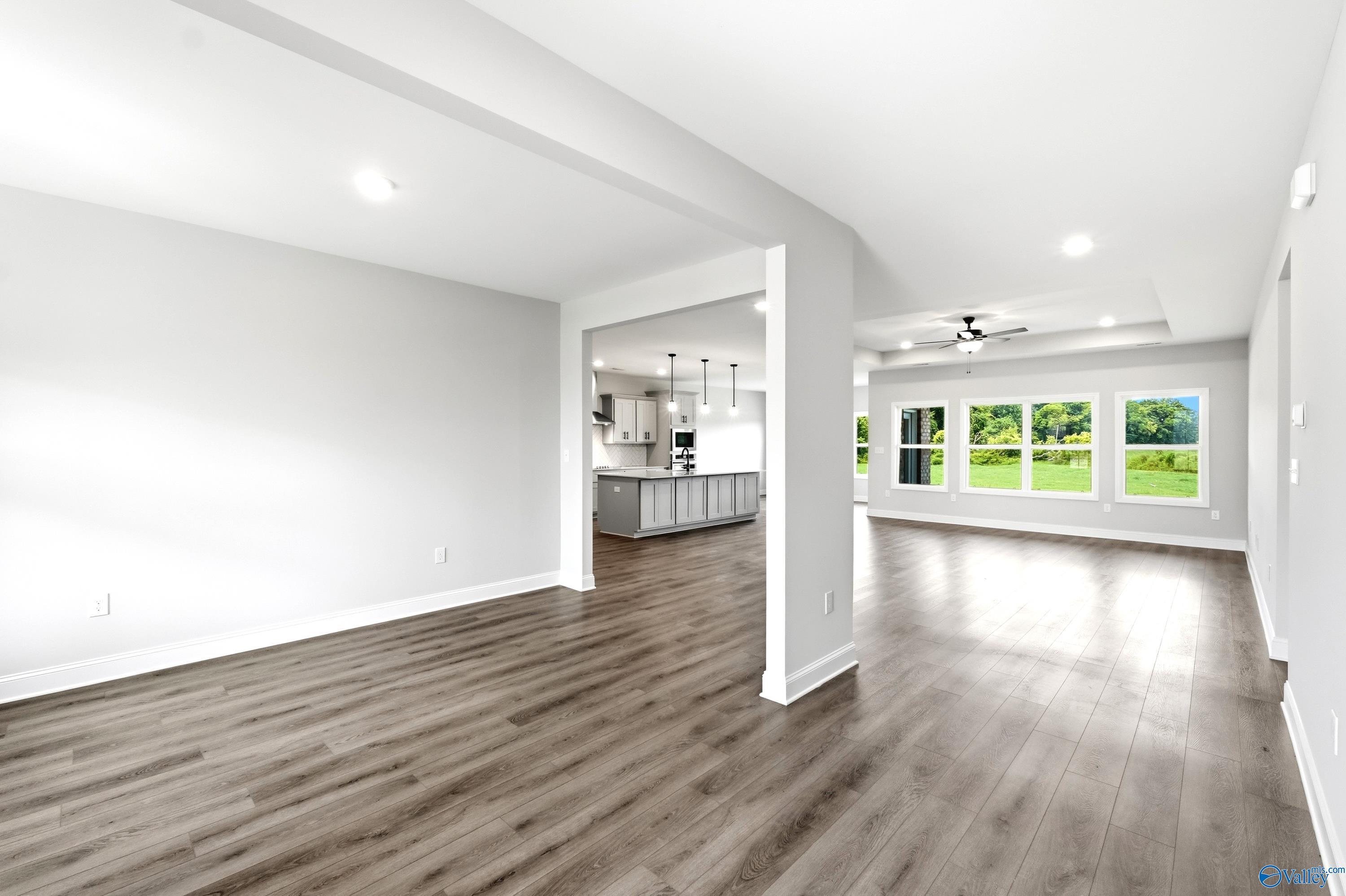 Open-concept living area with wood-style flooring in The Finleigh floor plan at Riverton Preserve, Huntsville, Alabama.