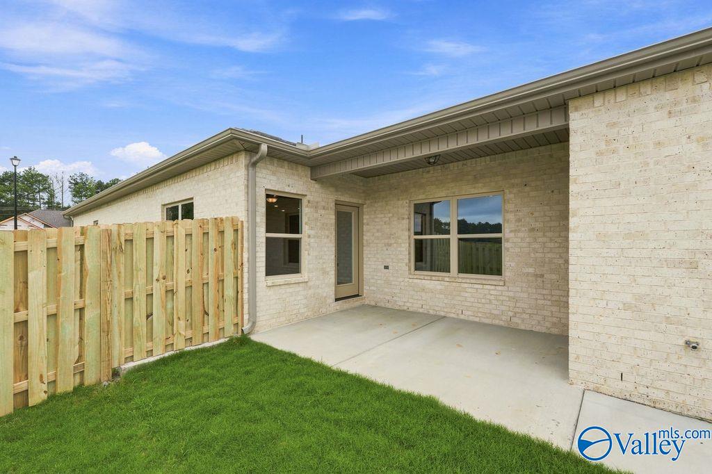 Covered back patio and brick exterior of The Camilla B floor plan at The Retreat at Cain Park in Hartselle, Alabama.