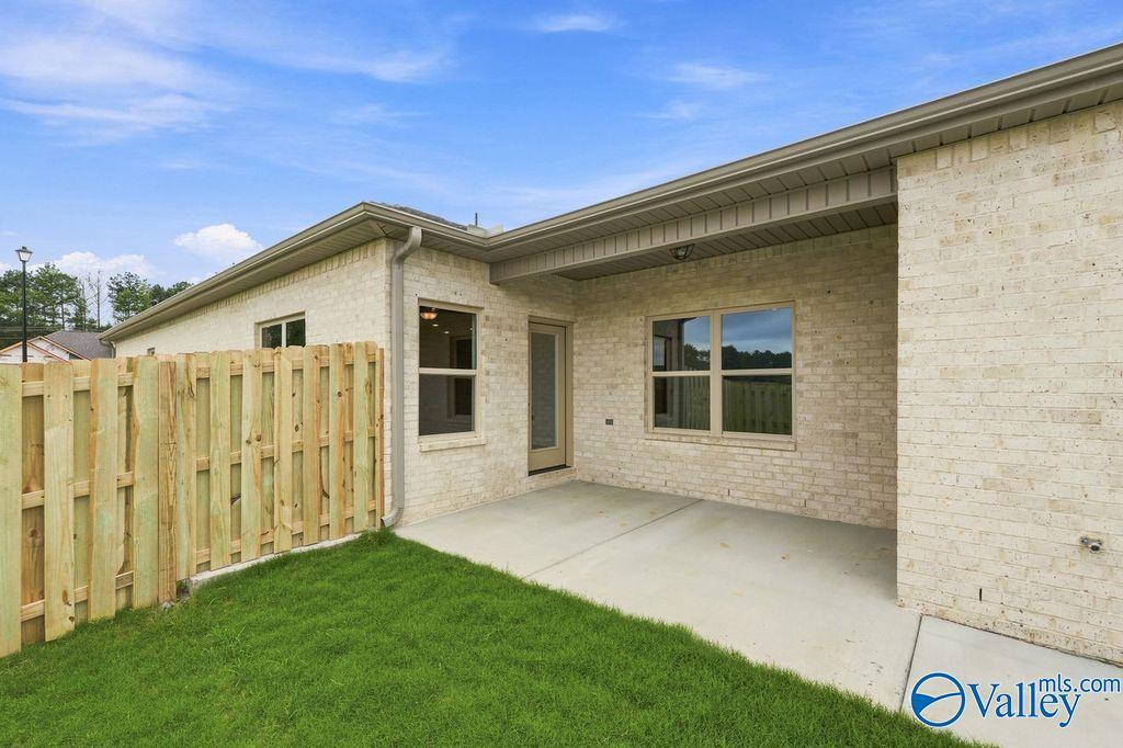 Covered back patio and brick exterior of The Camilla B floor plan at The Retreat at Cain Park in Hartselle, Alabama.
