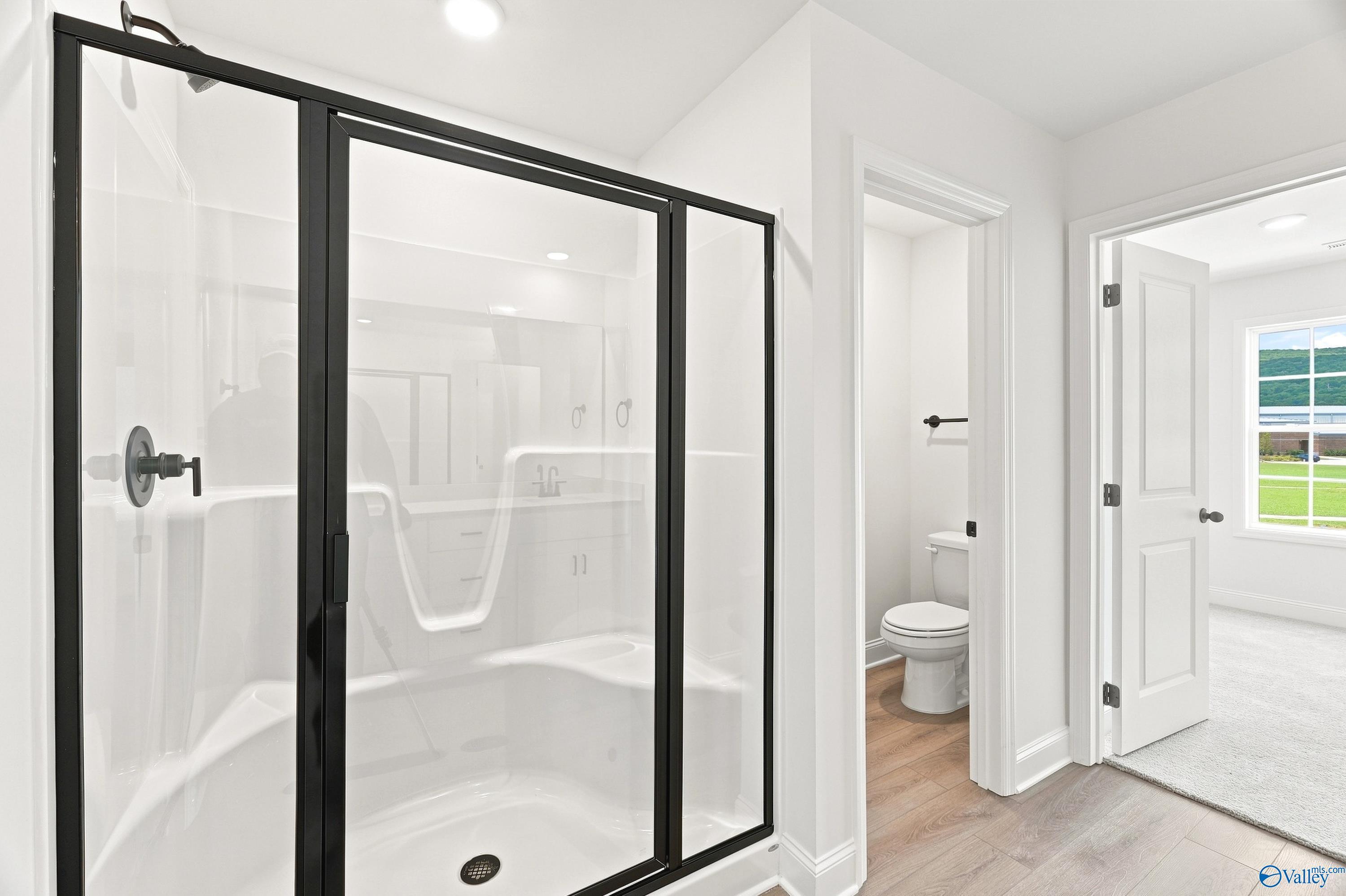 Modern walk-in shower with black frame in Davidson Homes The Shelby B floor plan, Jaguar Hills, Huntsville, Alabama.