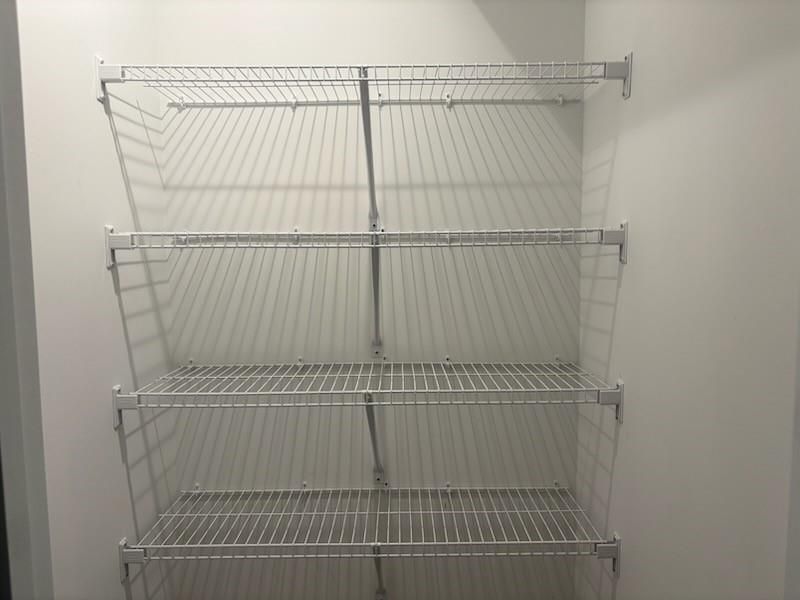 Spacious walk-in closet with multi-level wire shelving in Davidson Homes Marion A, Winder, Georgia