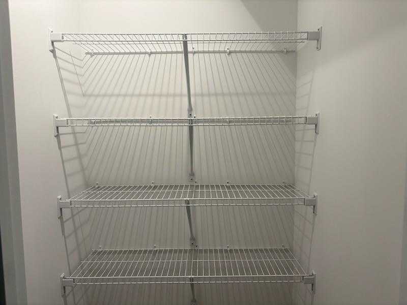 Spacious walk-in closet with multi-level wire shelving in Davidson Homes Marion A, Winder, Georgia