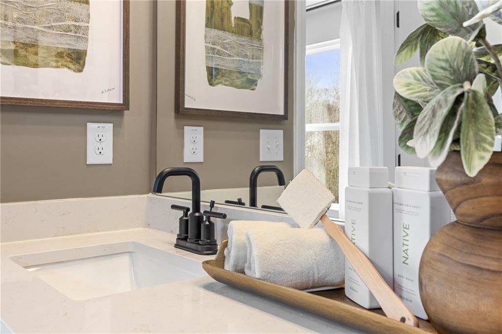 Modern bathroom vanity with matte black faucet and quartz countertop in The Rabun B floor plan at The Bluffs, Canton.