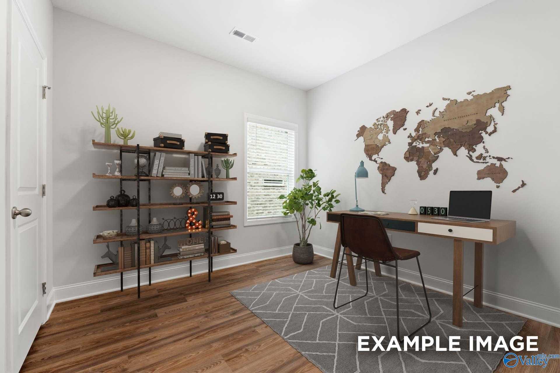 Cozy home office with wooden desk, potted plants, bookshelf and world map wall art in Davidson Homes The Cumberland, Decatur, Alabama