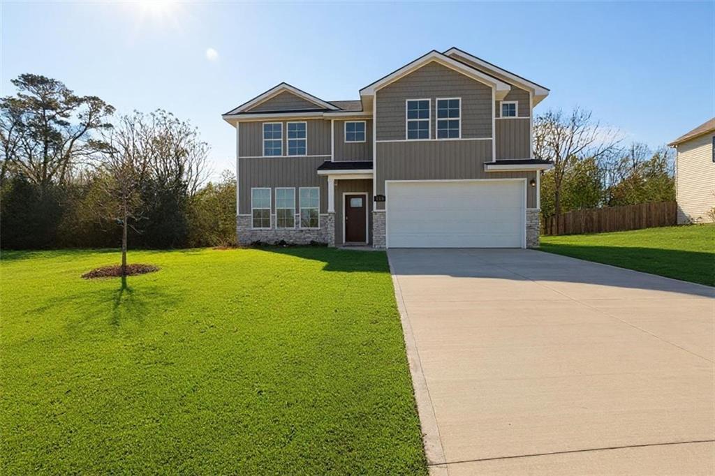 Two-story gray home with 2-car garage, driveway, and lush green lawn in Ivy Glen, Perry, Georgia - Evermore Homes The Stella