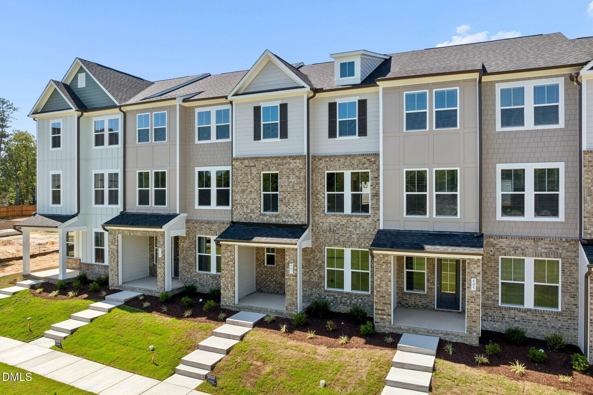 Modern brick townhome exteriors with covered porches at Forestville Yard Townhomes, Davidson Homes in Knightdale, North Carolina
