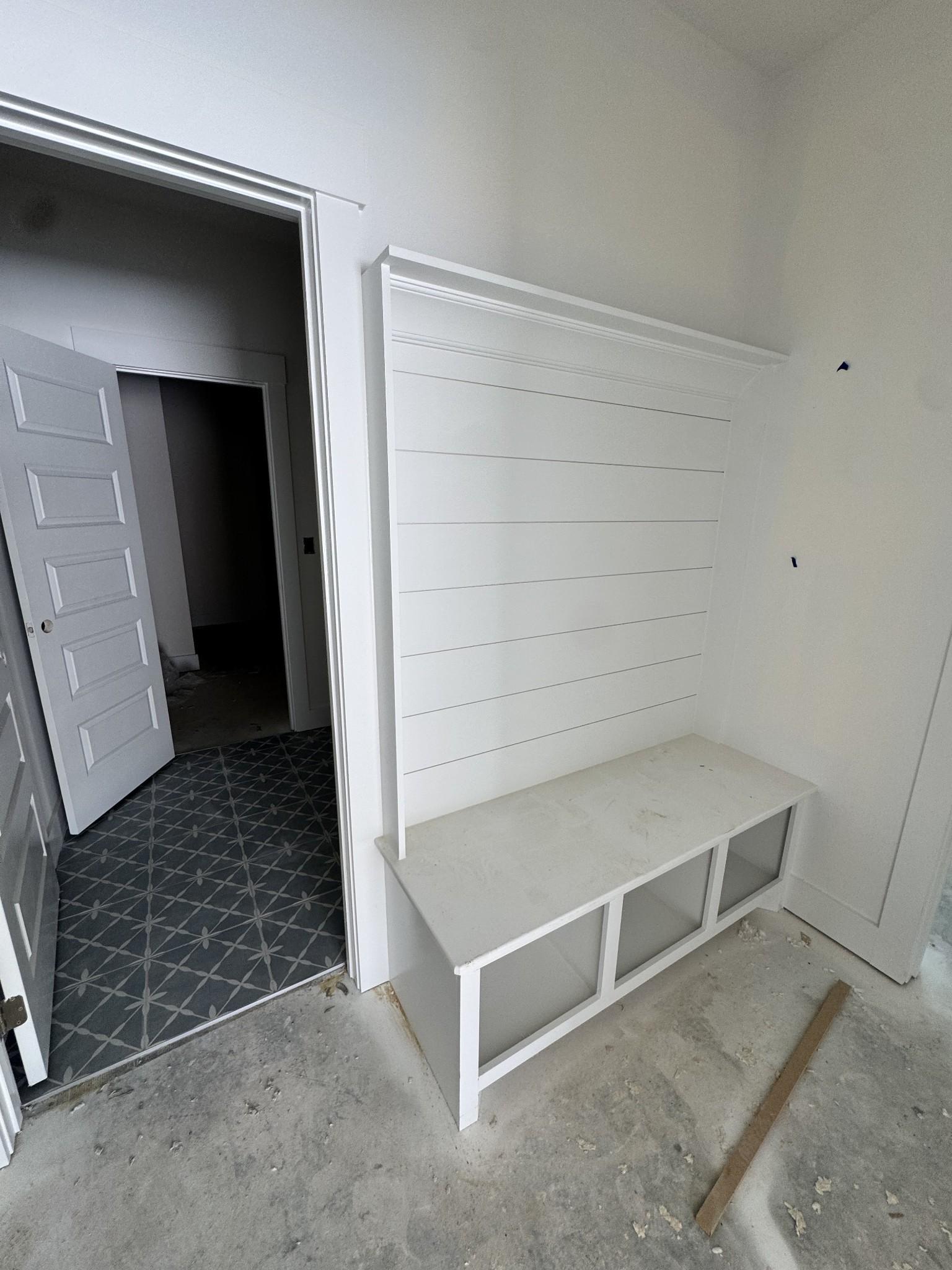 Custom white shiplap mudroom bench in The Prairie C floor plan at Woods Crossing, Gallatin, Tennessee.