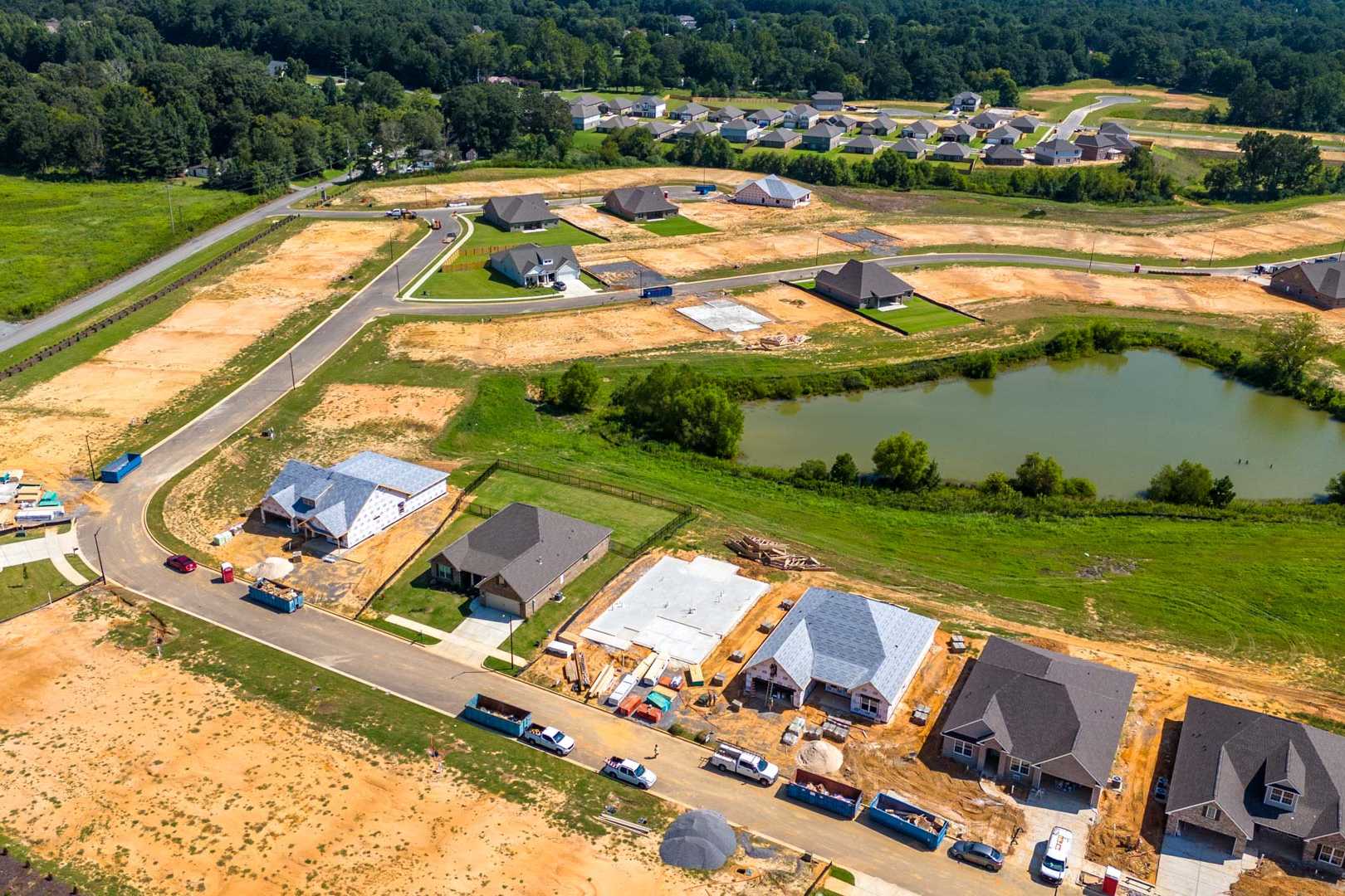 Aerial view of new homes under construction in North Ridge, Cullman Alabama by Davidson Homes with pond and green spaces