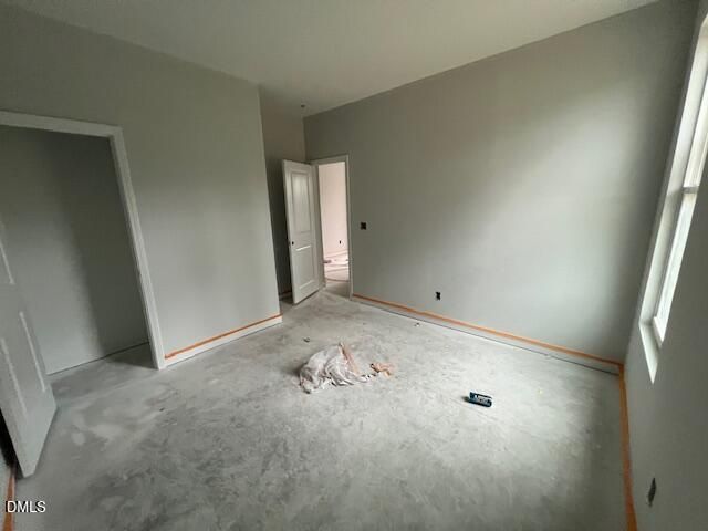 Unfinished bedroom with fresh gray paint and concrete floors in Davidson Homes' The Daphne C, Wellers Knoll, Lillington, NC