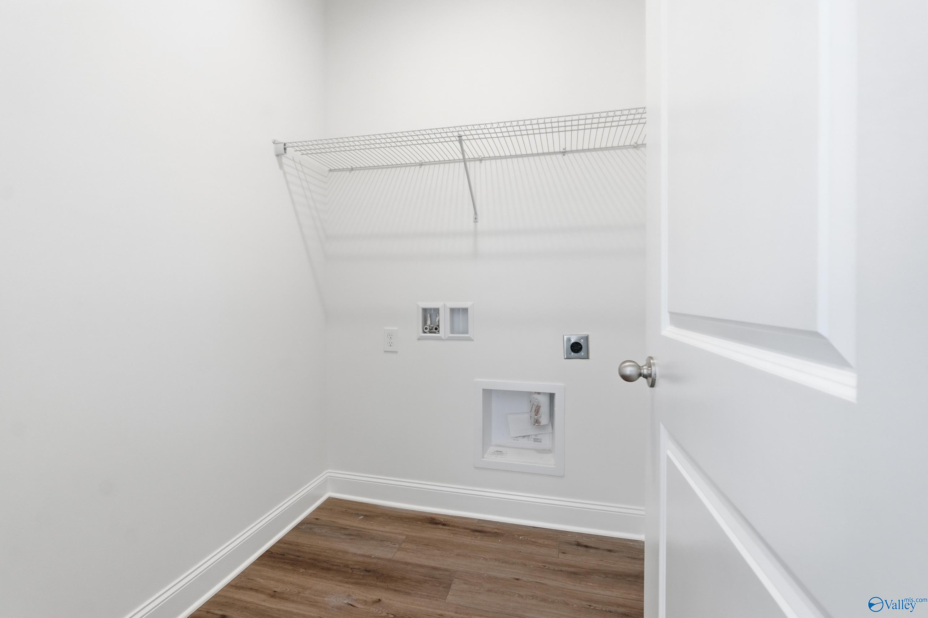 Spacious laundry room with wire shelving, washer-dryer hookups in Davidson Homes The Asheville C, Meridianville, Alabama