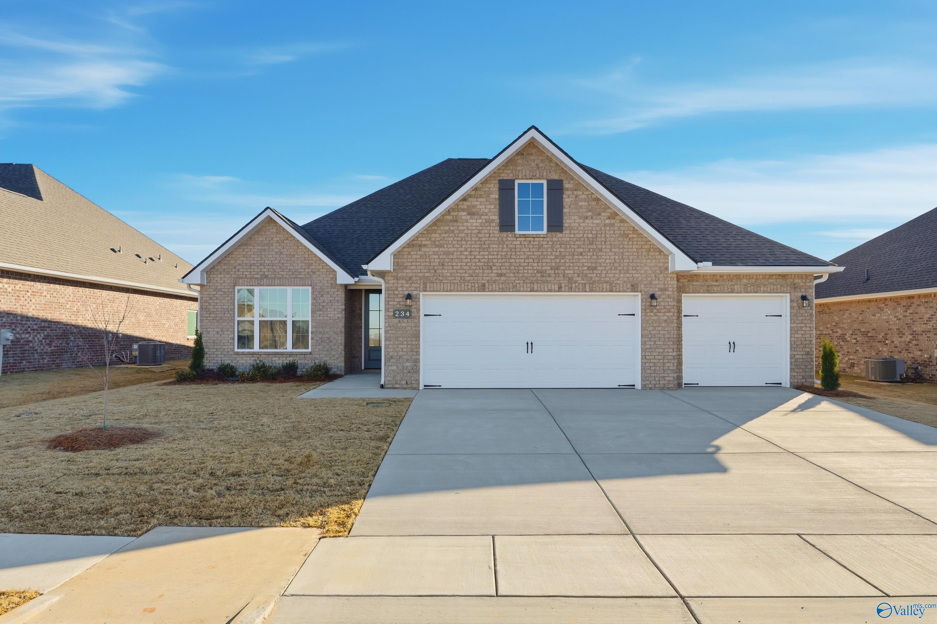 Brick single-story home with two-car garage and driveway in Kendall Downs, Toney, Alabama by Davidson Homes