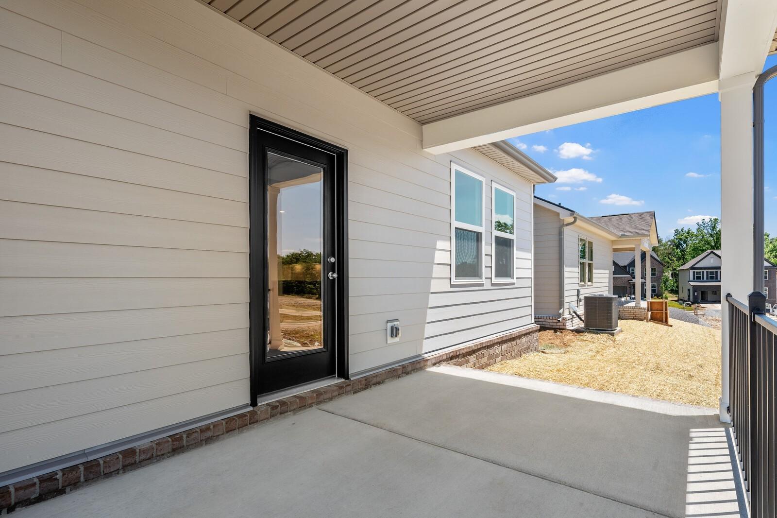 Covered patio and side exterior of The Cottonwood E floor plan at Woods Crossing in Gallatin, Tennessee.
