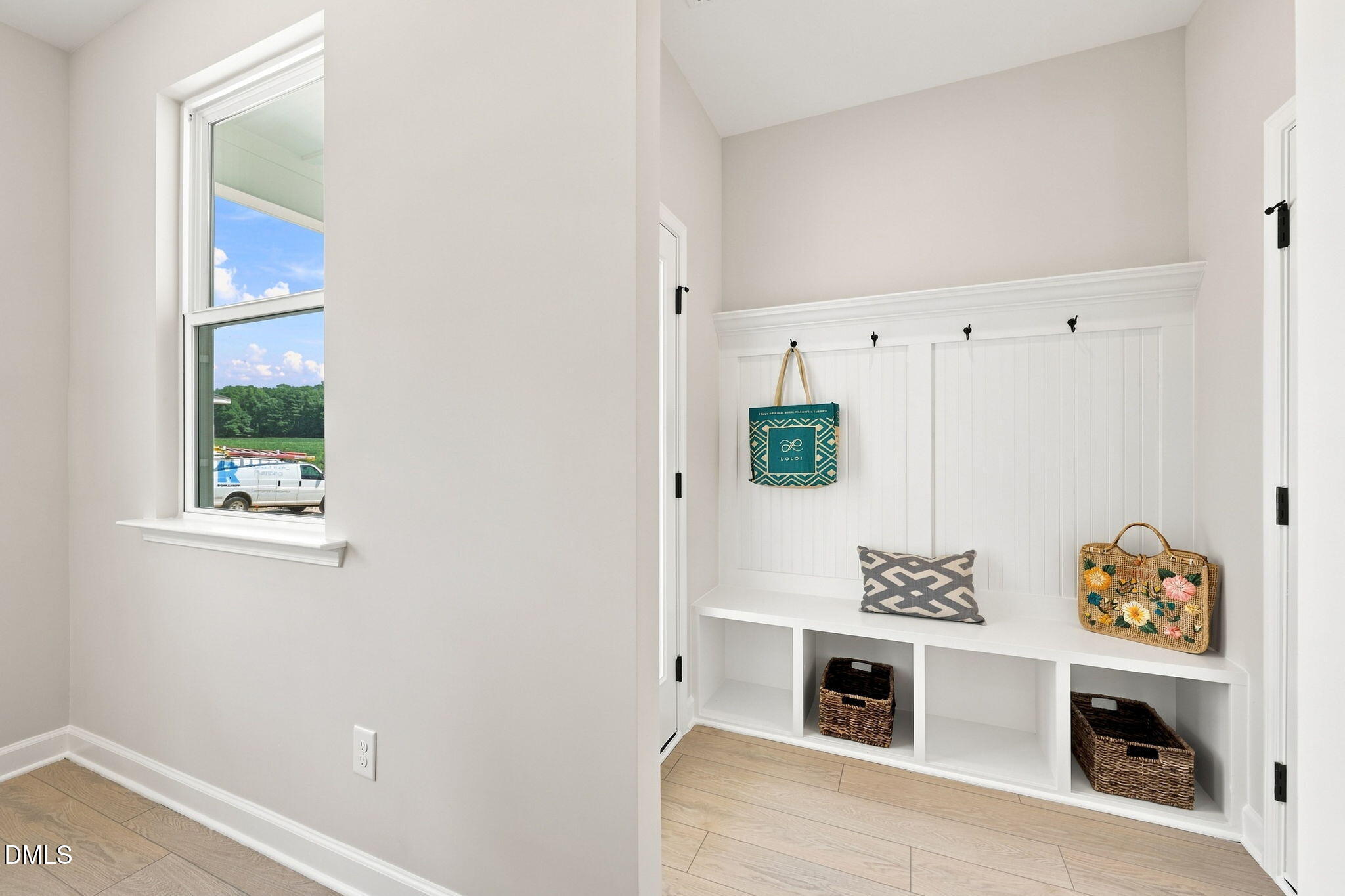 White mudroom drop zone with built-in bench and storage cubbies in The Harris C floor plan at Forestville Yard, Knightdale.