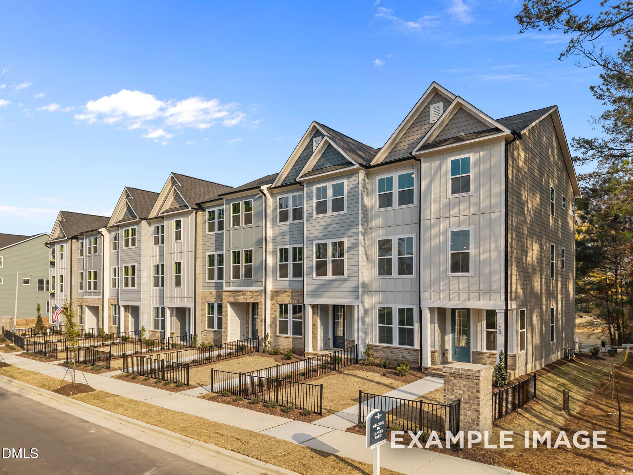 Modern 3-story townhomes with gray siding, gabled roofs, and front stoops in Camden Park, Knightdale, North Carolina by Davidson Homes