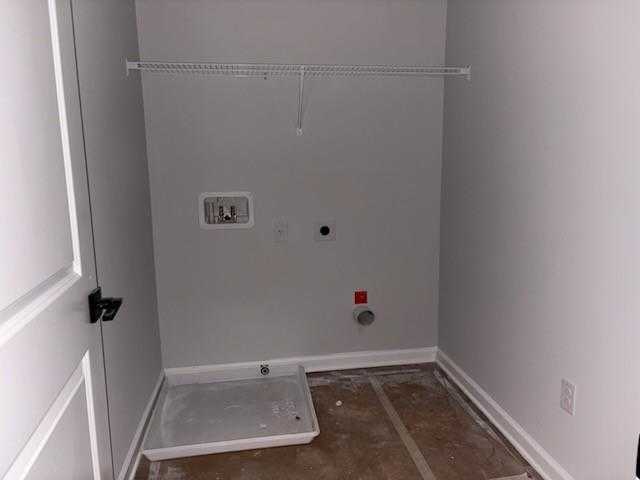 Spacious laundry room with washer/dryer hookups, closet rod, and gray walls in Davidson Homes The Rabun C, Winder, Georgia