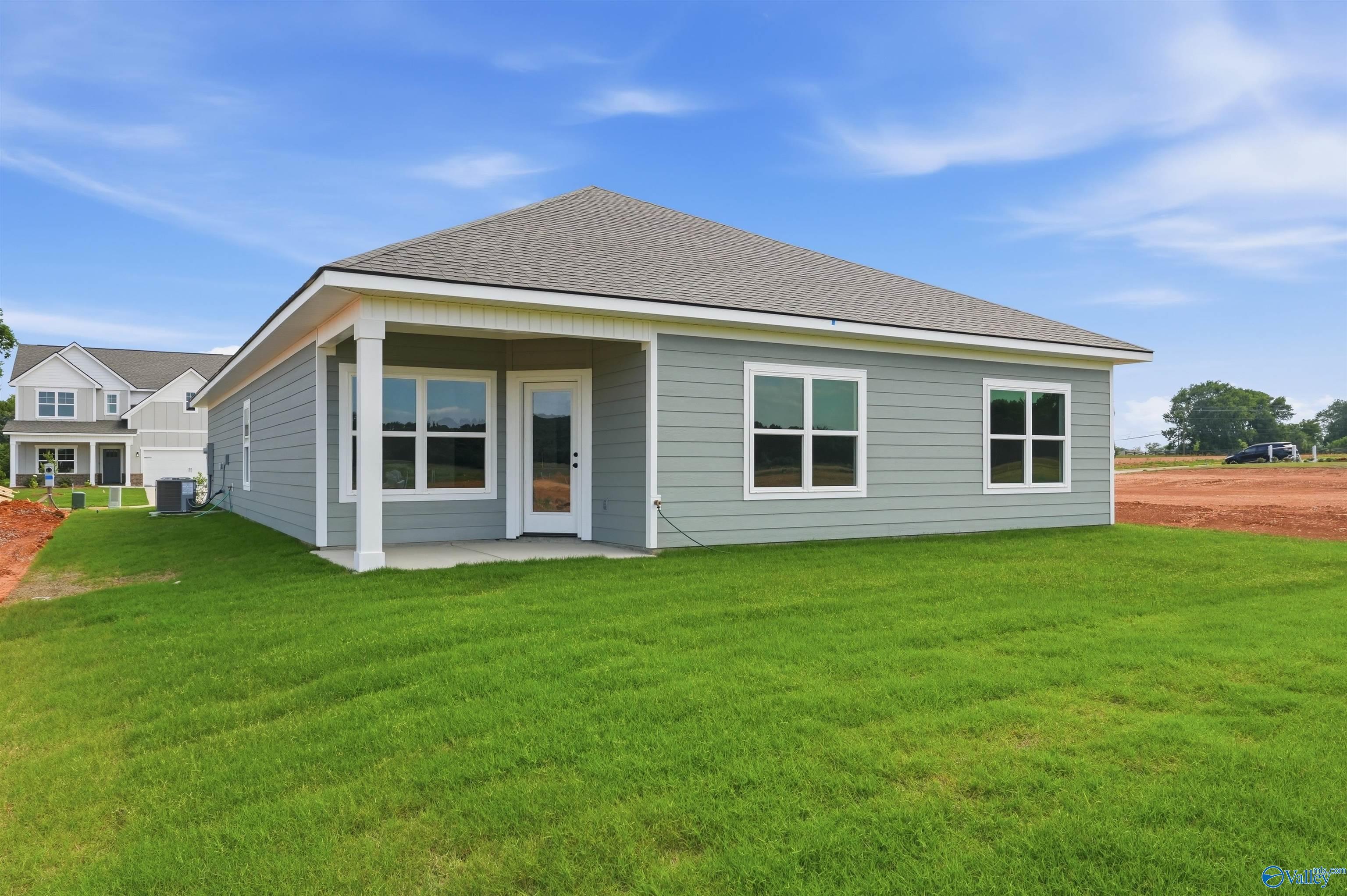 Back exterior view of The Daphne F floor plan by Davidson Homes in Berry Cove, New Market, Alabama with a spacious yard.