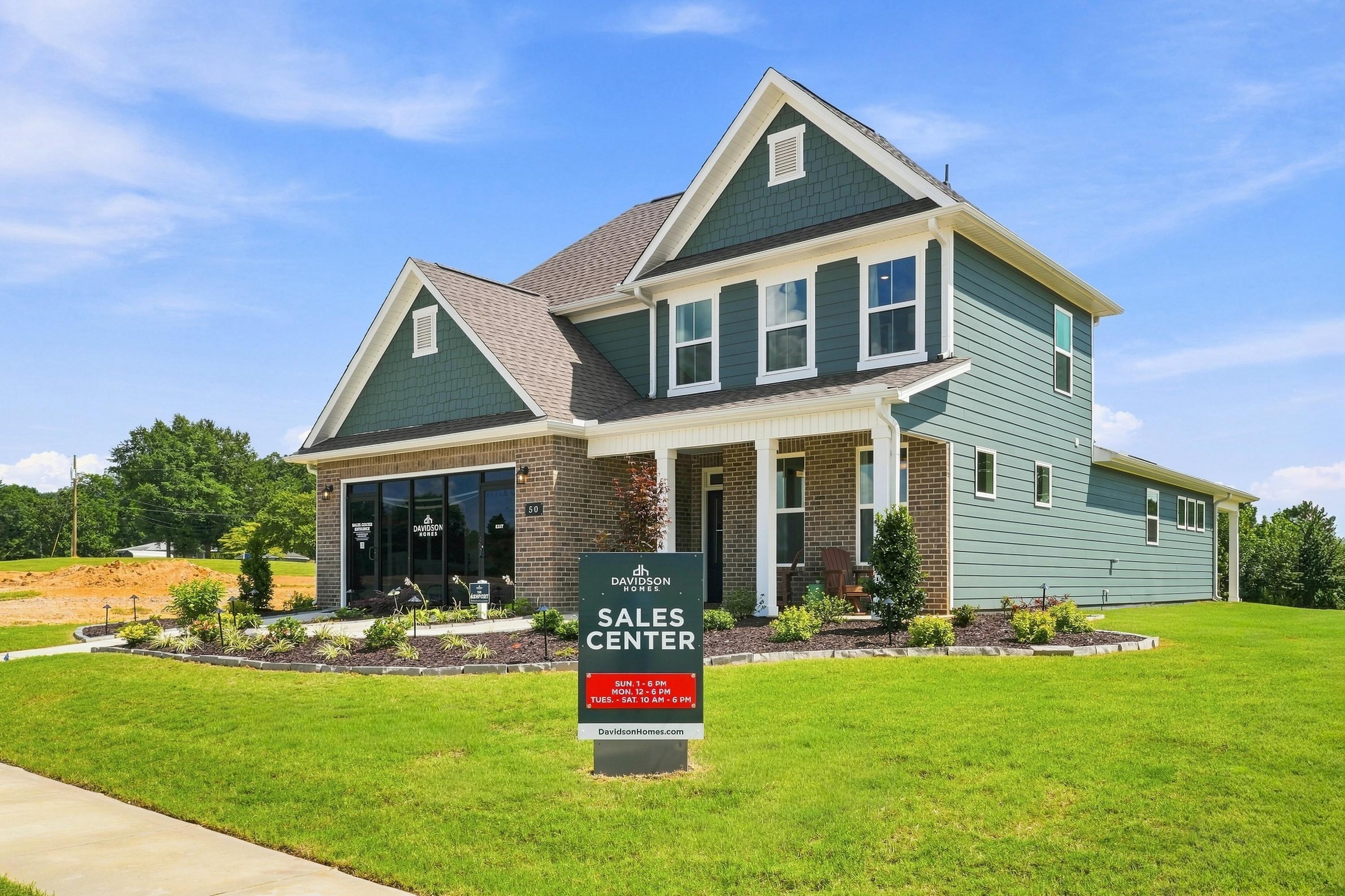 Davidson Homes sales center at Evergreen Mill in Madison, Alabama, featuring a two-story home with brick and siding exterior.