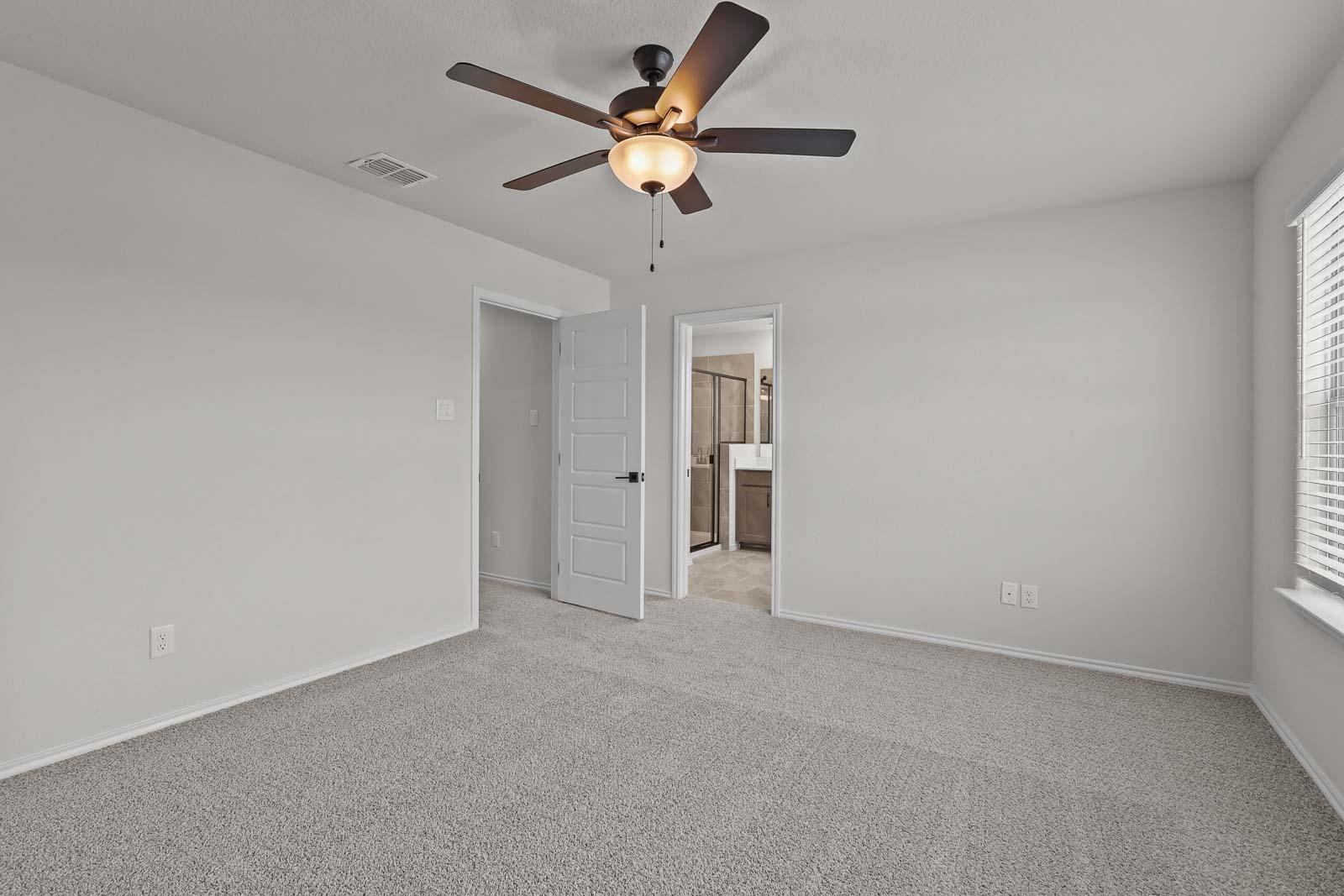 Spacious upper-floor master bedroom in The Florence B by Davidson Homes, featuring neutral carpet and an en-suite bathroom.