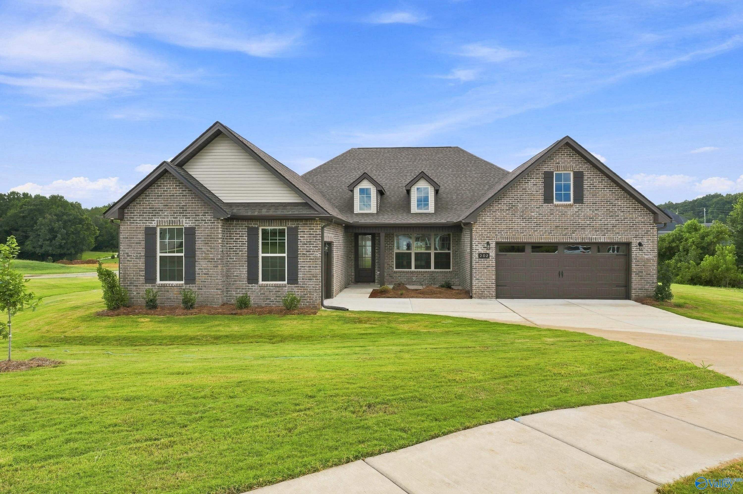 The Valencia floor plan by Davidson Homes, a 1-story brick exterior home with a 3-car garage in Riverton Preserve, Huntsville.