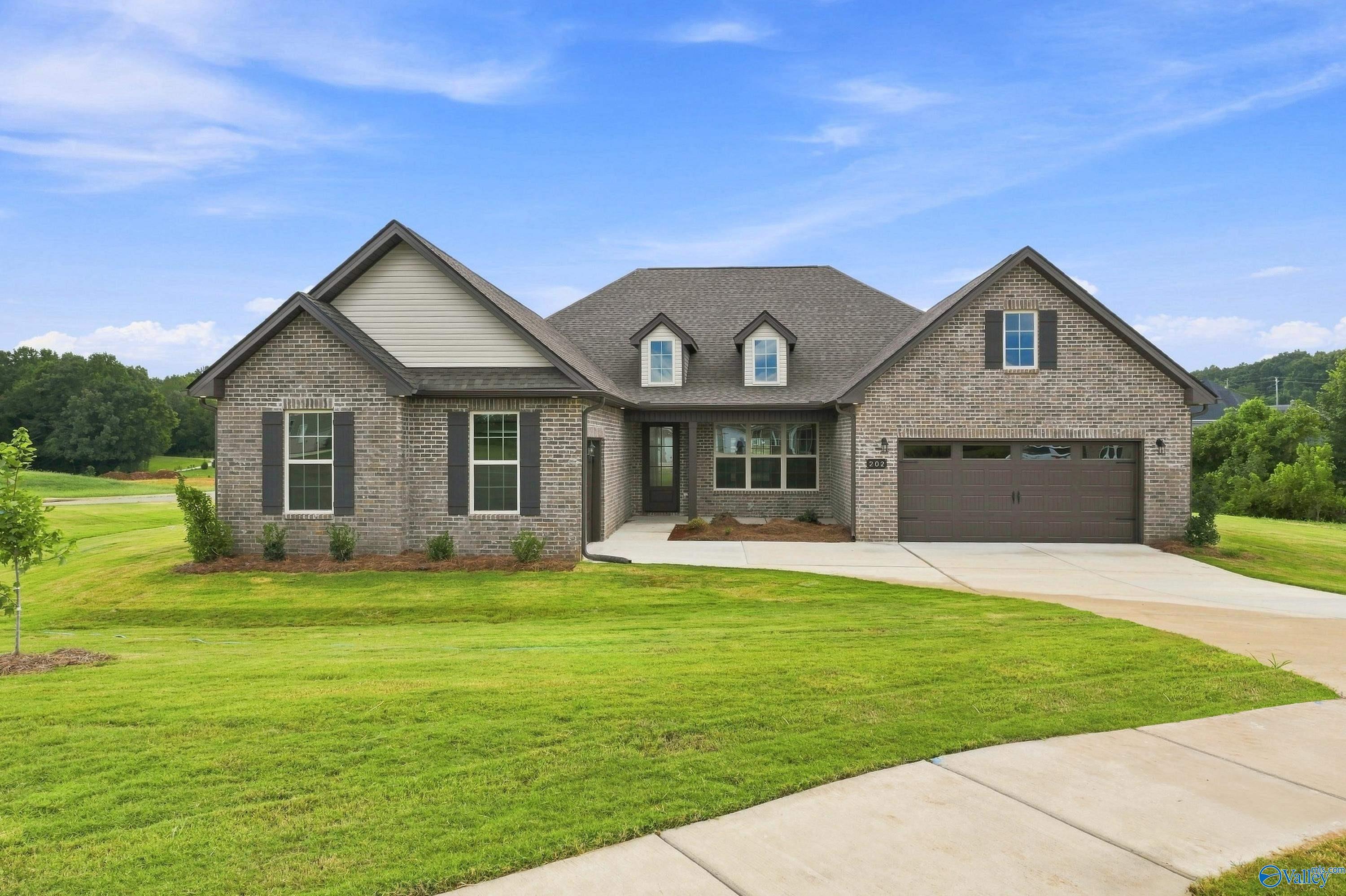 The Valencia floor plan by Davidson Homes, a 1-story brick exterior home with a 3-car garage in Riverton Preserve, Huntsville.