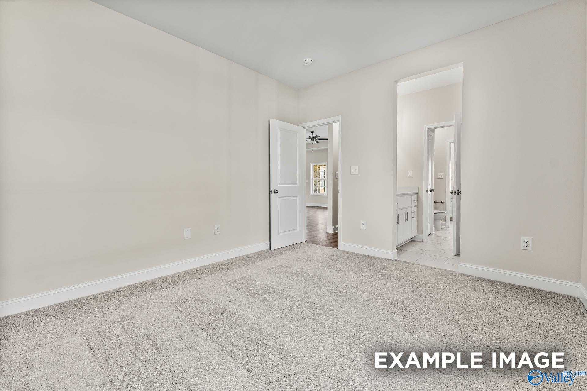 Spacious master bedroom with en-suite bath and adjacent closet in Davidson Homes The Finleigh, Meridianville, Alabama