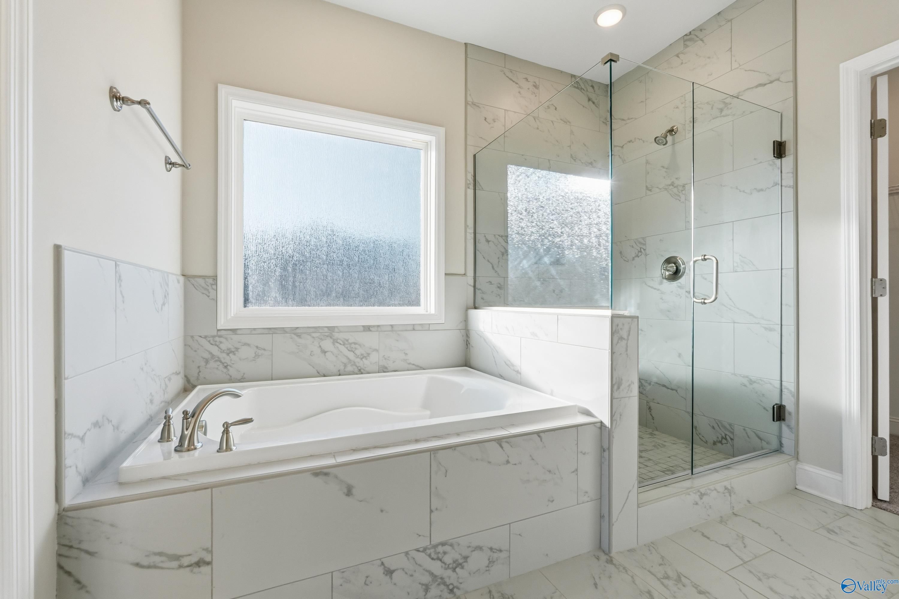 Luxurious master bathroom featuring freestanding tub, glass shower enclosure, subway tile in Davidson Homes The Montgomery B, Toney, AL