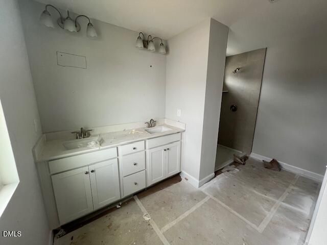 Modern master bathroom with double vanity, white cabinets, and glass walk-in shower in Davidson Homes Adalynn B, Lillington NC