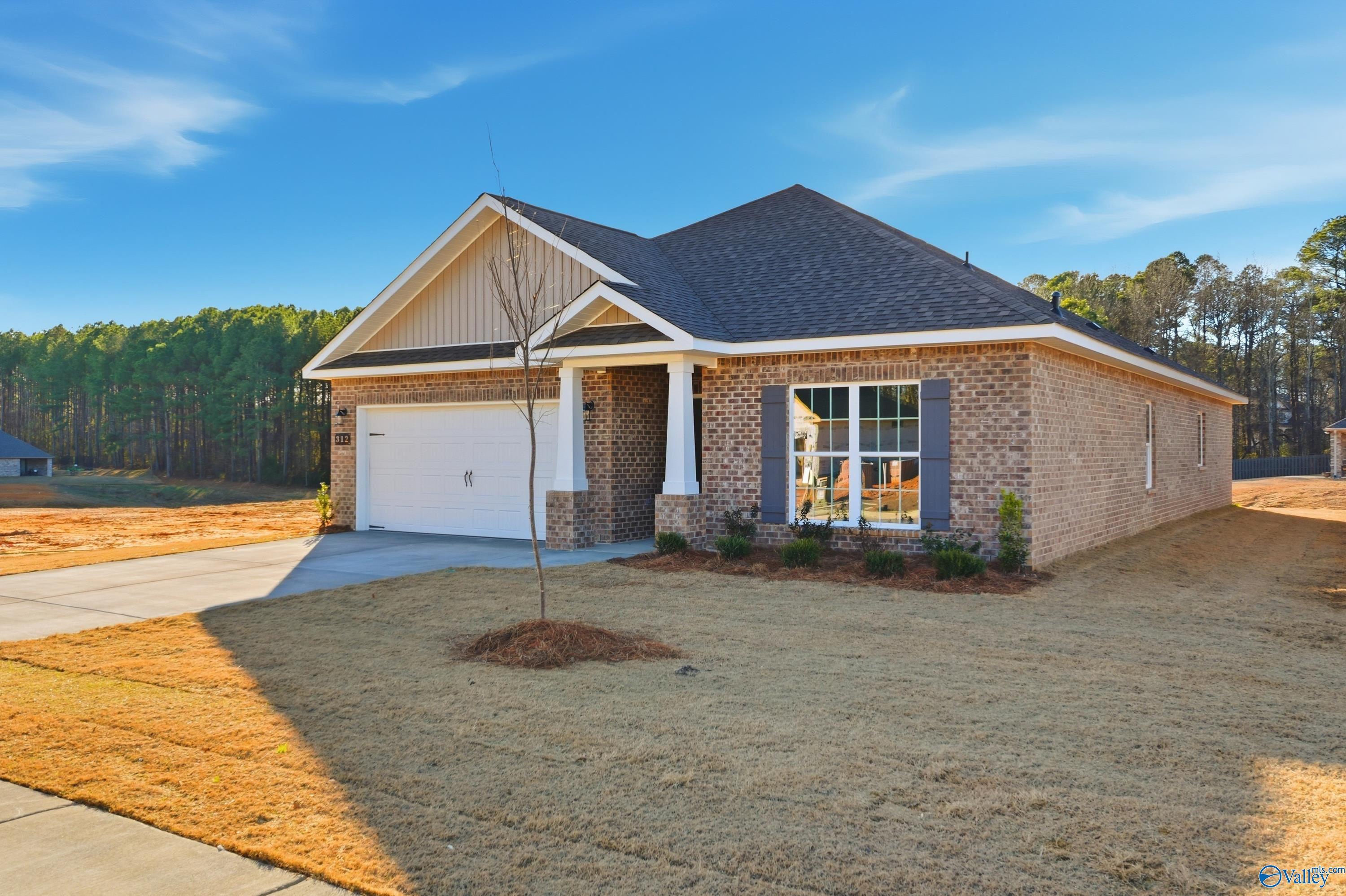 Modern brick 1-story home with 2-car garage, columned porch, and gabled roof in The Highlands, Arab, Alabama - Davidson Homes Daphne C