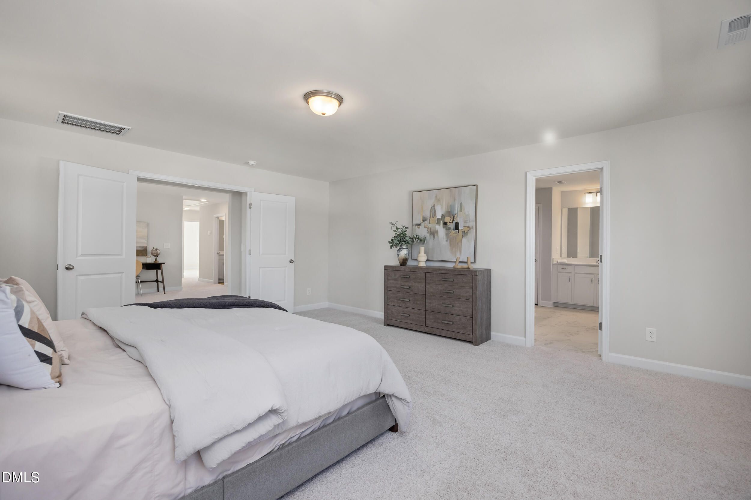 Spacious master bedroom with king bed, dresser, and en-suite bathroom in Davidson Homes The Preston C, Lillington, NC