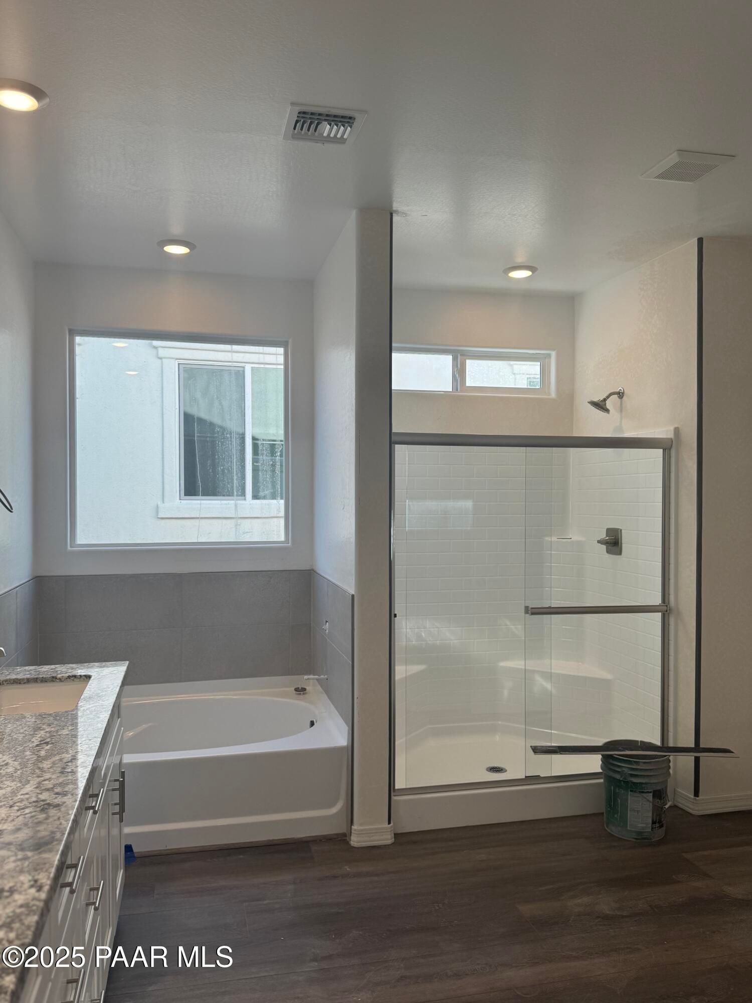 Modern master bathroom featuring soaking tub, glass walk-in shower, and quartz vanity in Davidson Homes The Summit A, Prescott, AZ