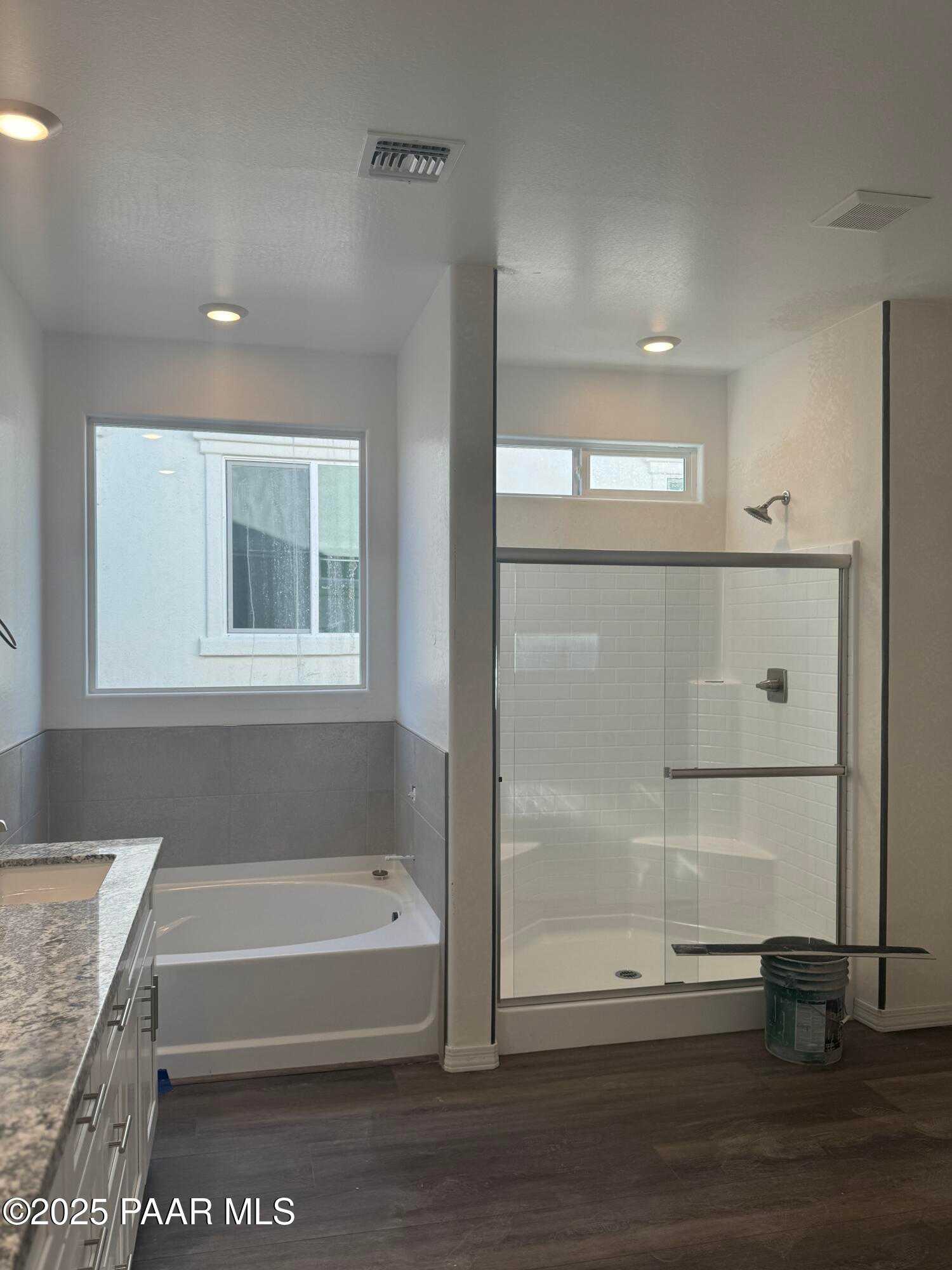Modern master bathroom featuring soaking tub, glass walk-in shower, and quartz vanity in Davidson Homes The Summit A, Prescott, AZ