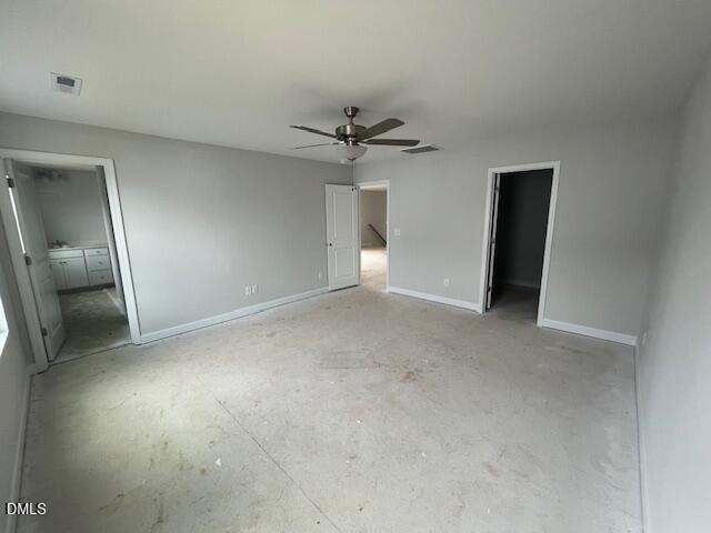 Spacious empty master bedroom with gray walls, ceiling fan, en-suite bath in Davidson Homes The Adalynn B, Lillington, NC