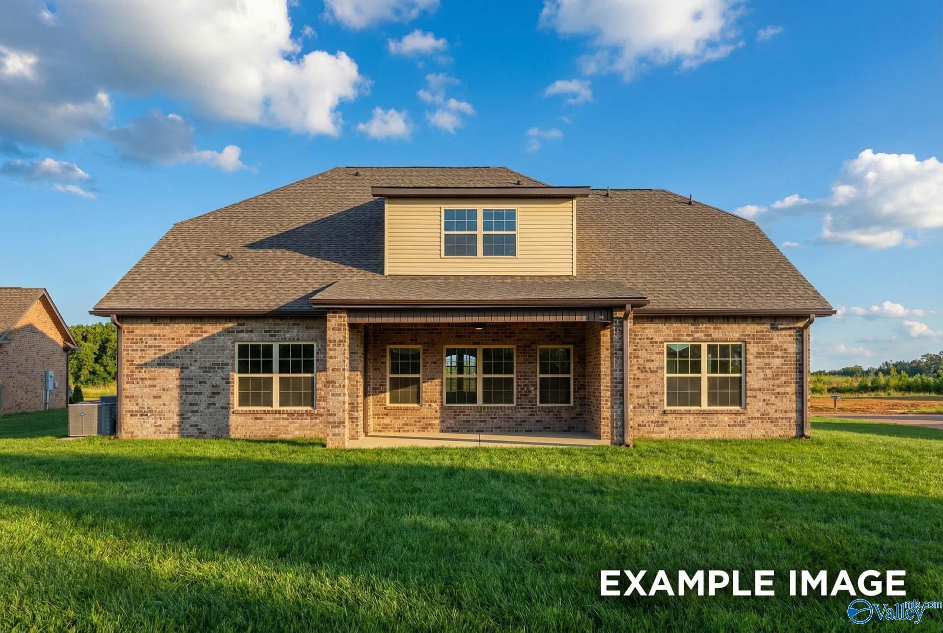 Two-story brick home with covered front porch, dormer window, and green lawn in Hollon Meadow, Decatur, Alabama