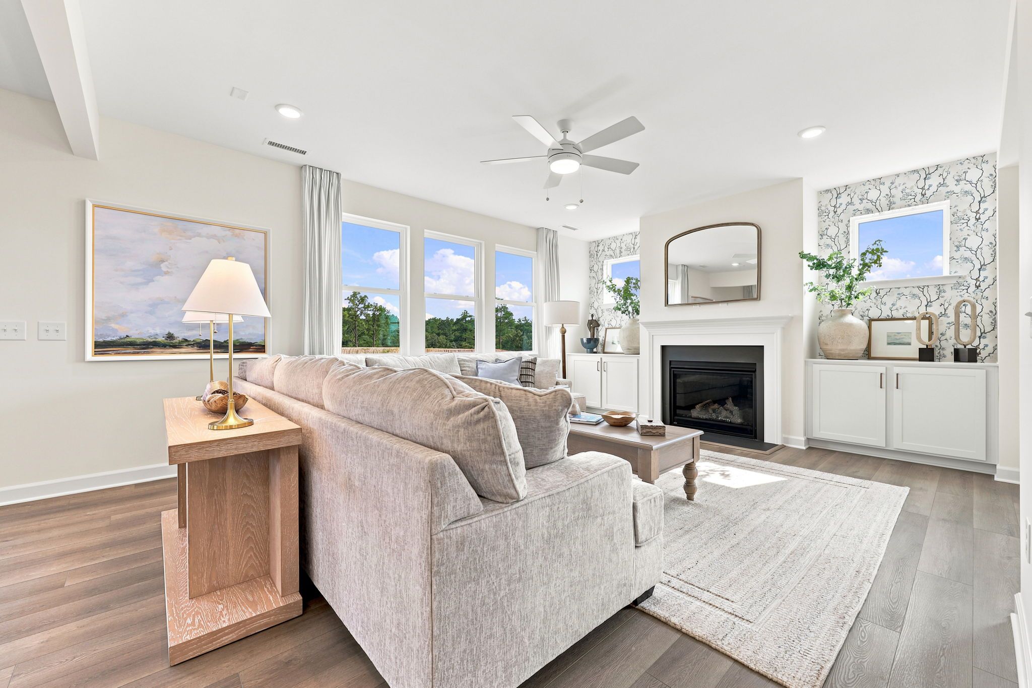 Bright living room with fireplace and modern decor at Montrose in Aberdeen, NC by Davidson Homes