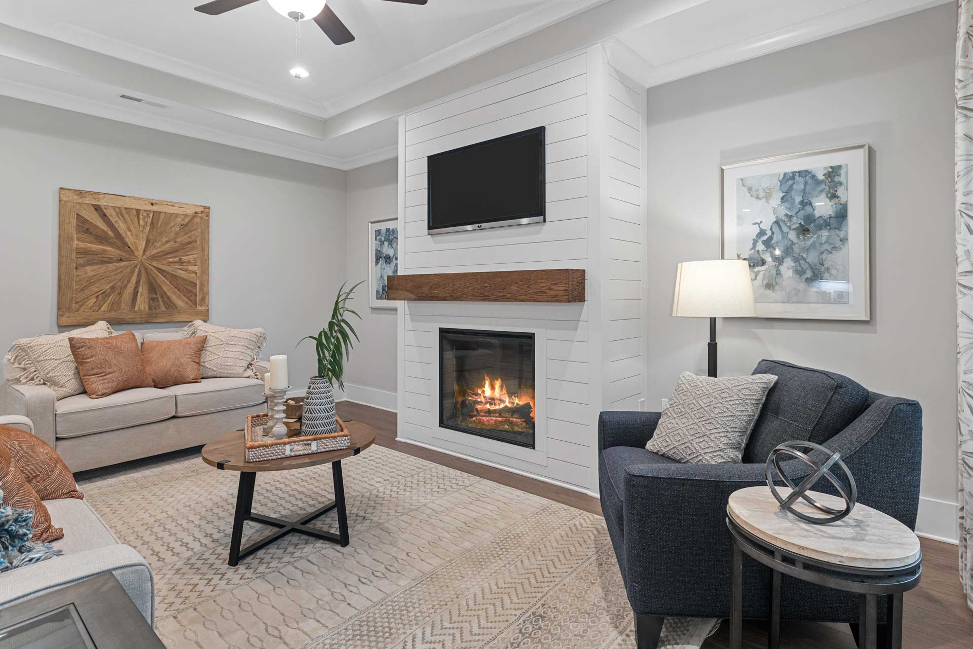 Cozy living room at Monteagle Cove in Owens Cross Roads, Alabama with shiplap gas fireplace, beige sofa, and modern decor