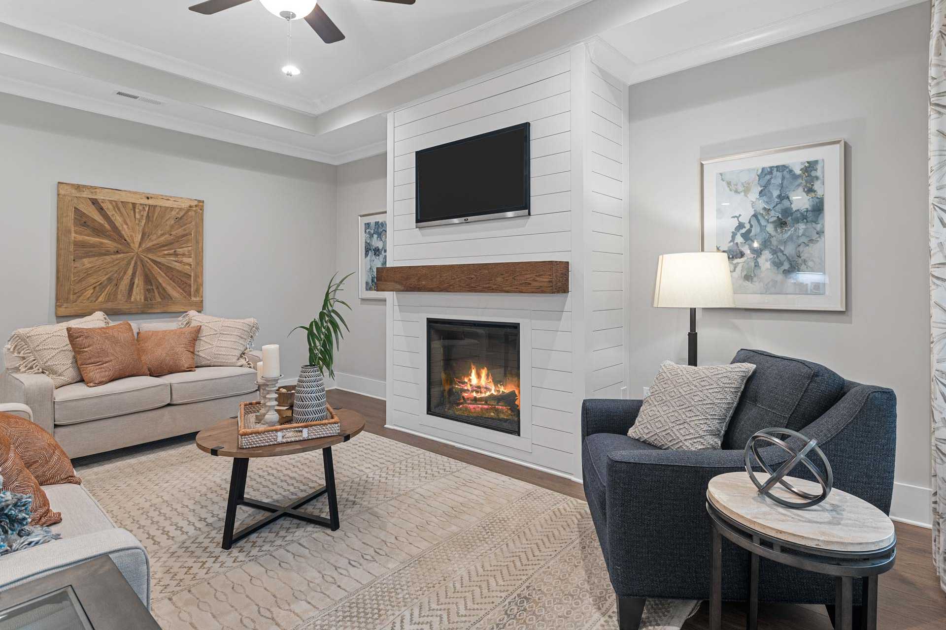 Cozy living room at Monteagle Cove in Owens Cross Roads, Alabama with shiplap gas fireplace, beige sofa, and modern decor