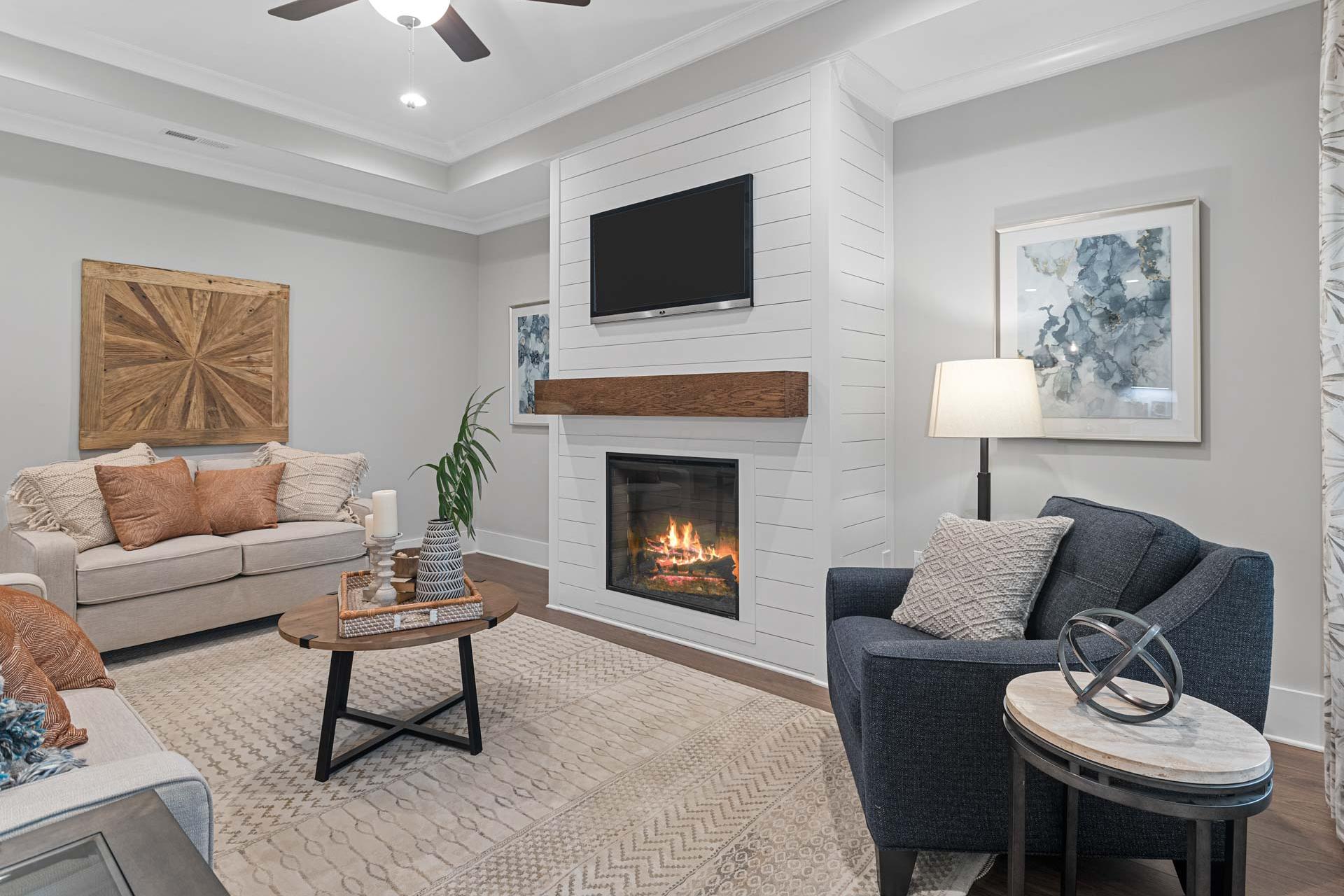 Cozy living room at Monteagle Cove in Owens Cross Roads, Alabama with shiplap gas fireplace, beige sofa, and modern decor