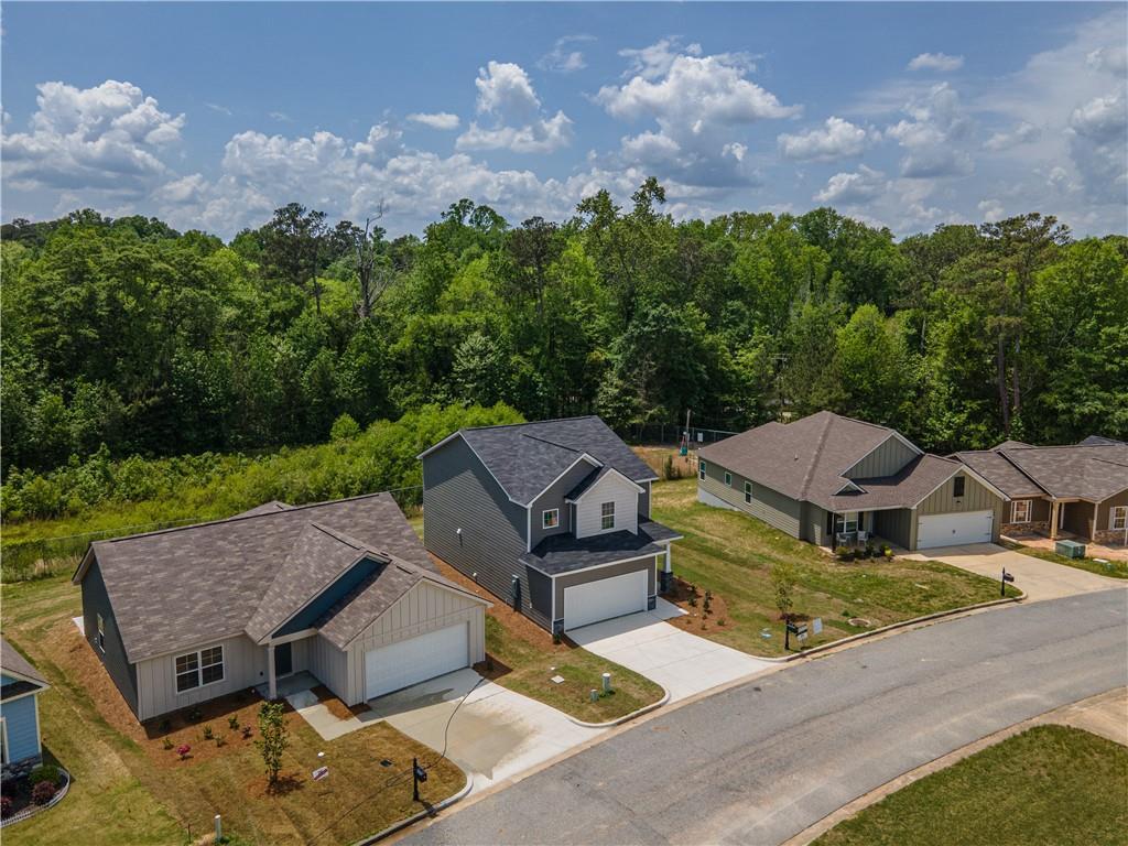 Aerial view of modern 3-bedroom Davidson Homes with 2-car garages in wooded Summer Vineyard, Phenix City, Alabama