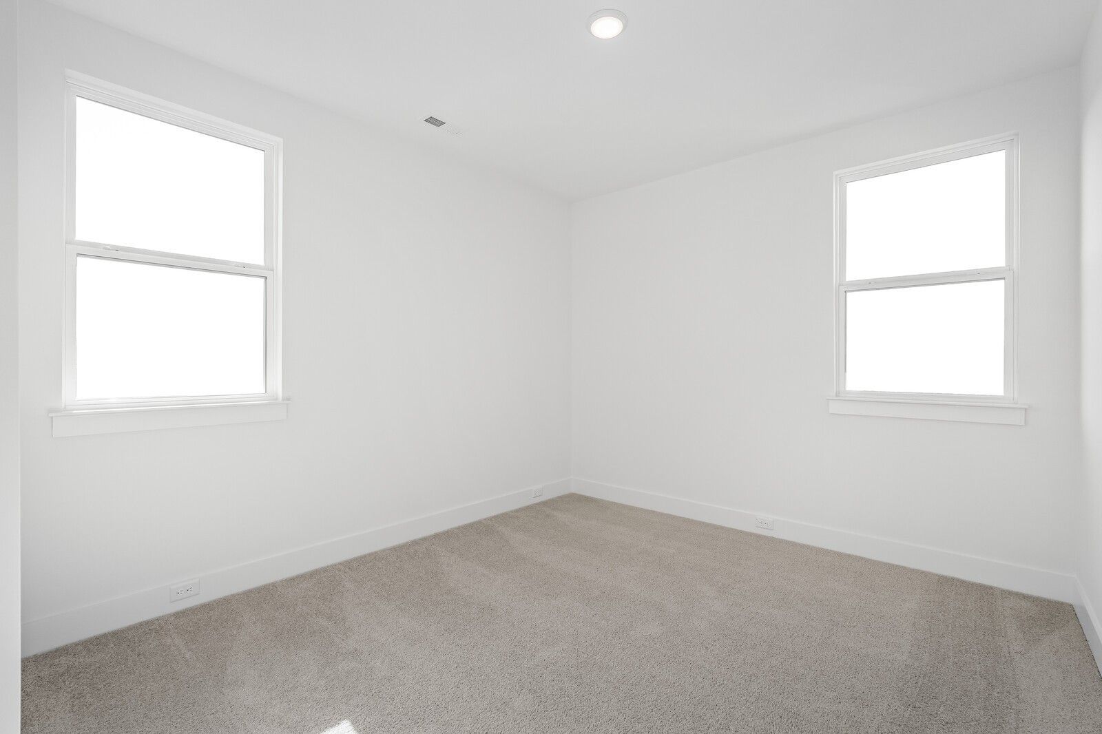 Bright empty bedroom with double-hung windows and neutral carpet in The Alston A, Shelton Square, Murfreesboro TN