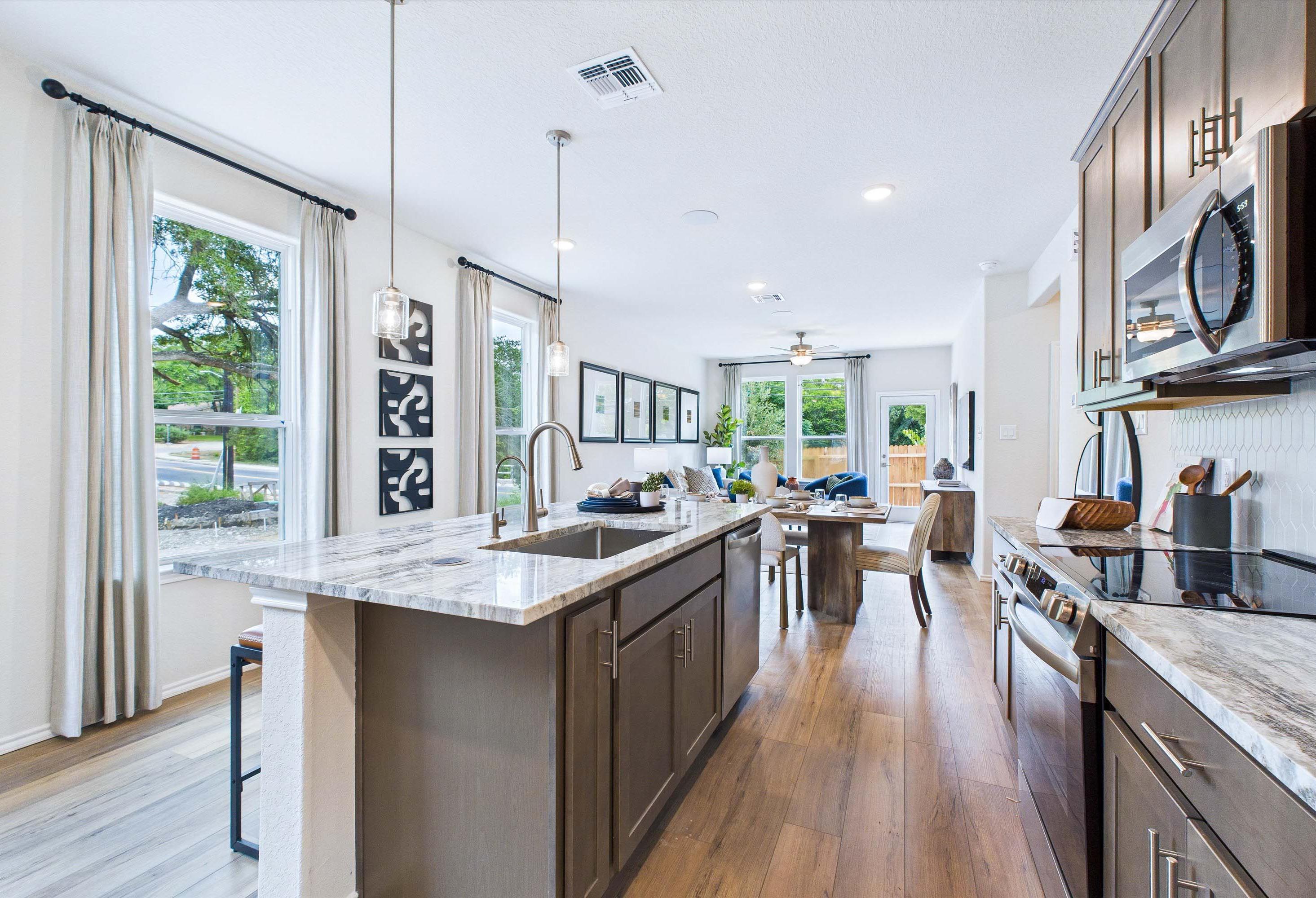 Open-concept kitchen and dining area in The Gillian C by Davidson Homes, featuring a large island and modern finishes.