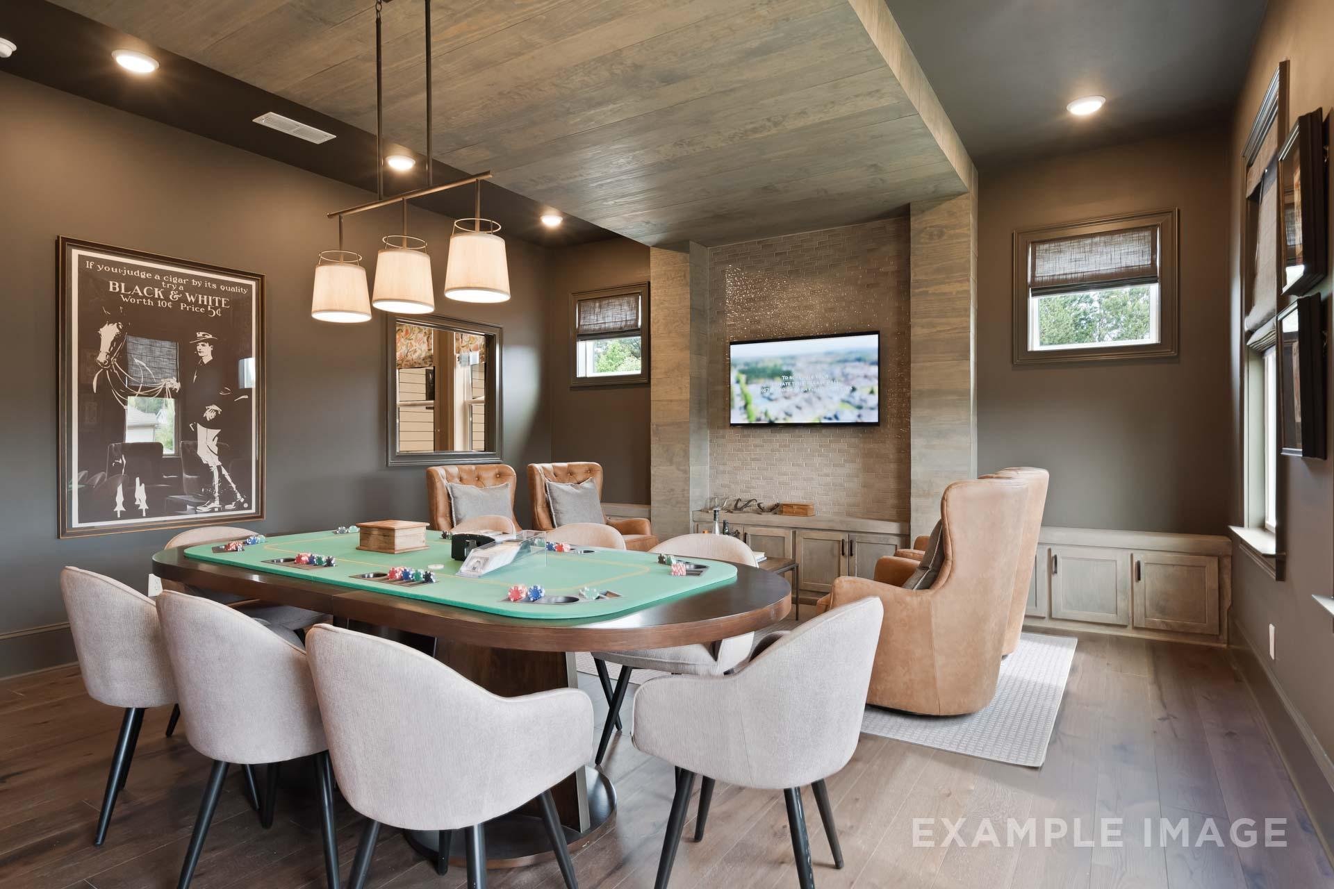 Spacious game room in The Seaside C featuring oval poker table, leather chairs, built-in bar, wall TV, and rustic wood ceiling