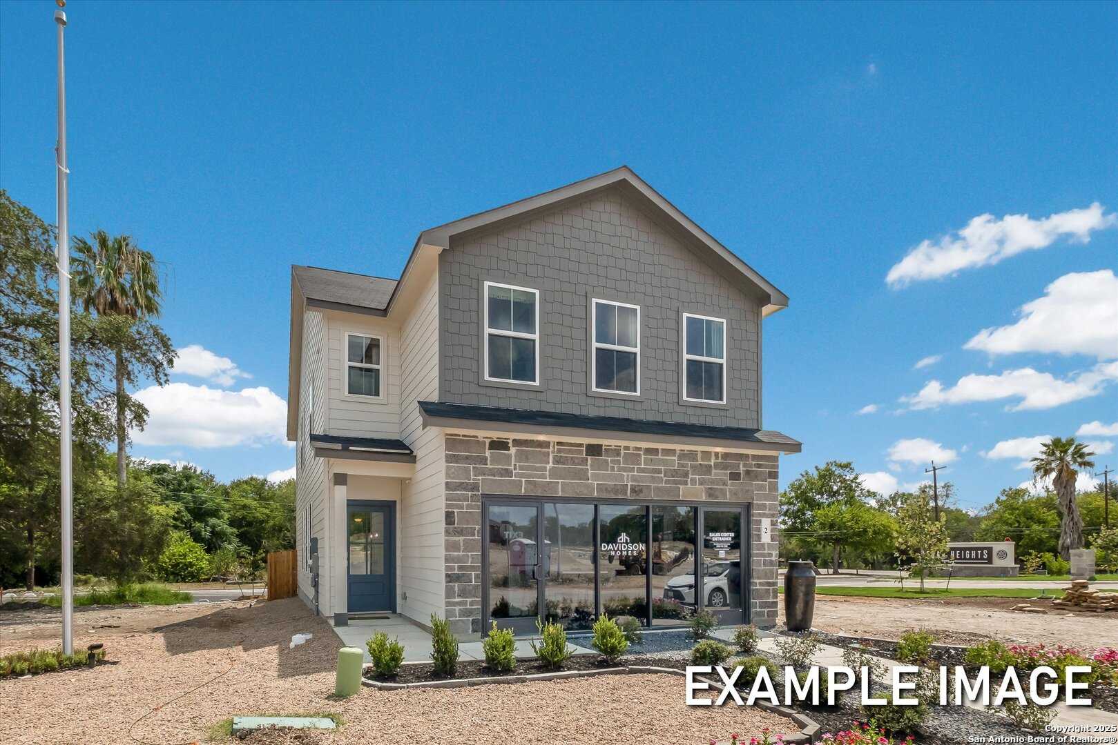 Modern two-story 4-bedroom home with gray siding, stone accents, and lush landscaping in Meadows at Oak Creek, San Antonio, Texas