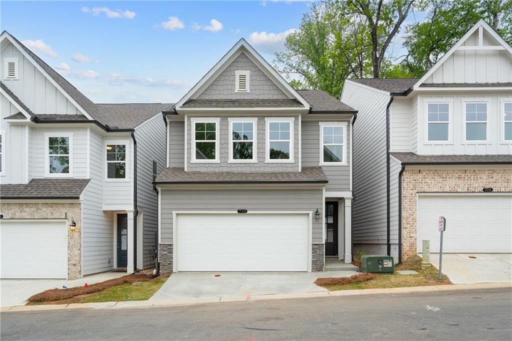 Modern gray two-story townhome with 2-car garage and white trim in The Village at Shallowford, Kennesaw, Georgia - Davidson Homes Marion B