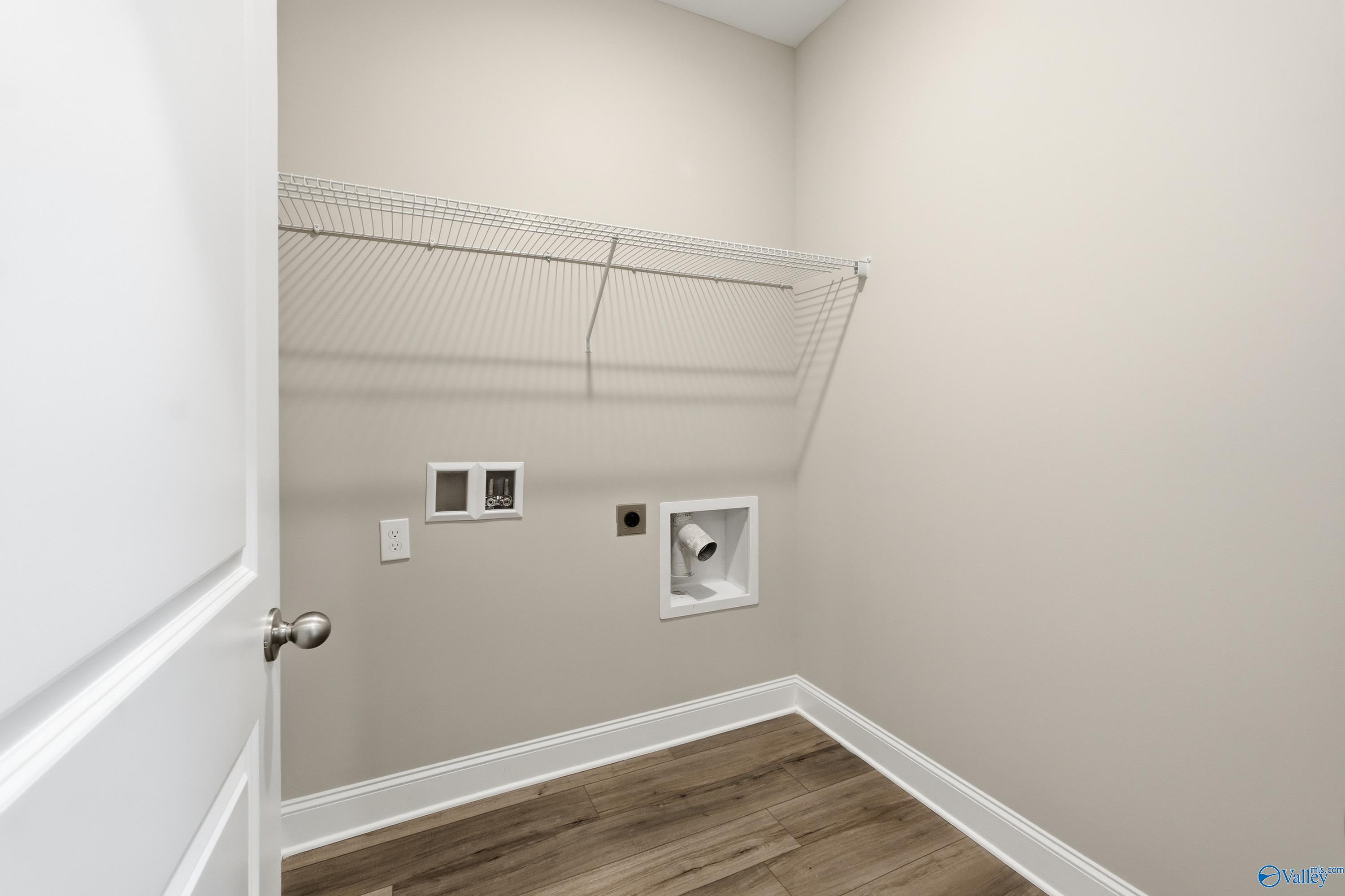 Functional laundry room with utility sink, wire shelving, outlets in Davidson Homes The Franklin C, New Market, Alabama