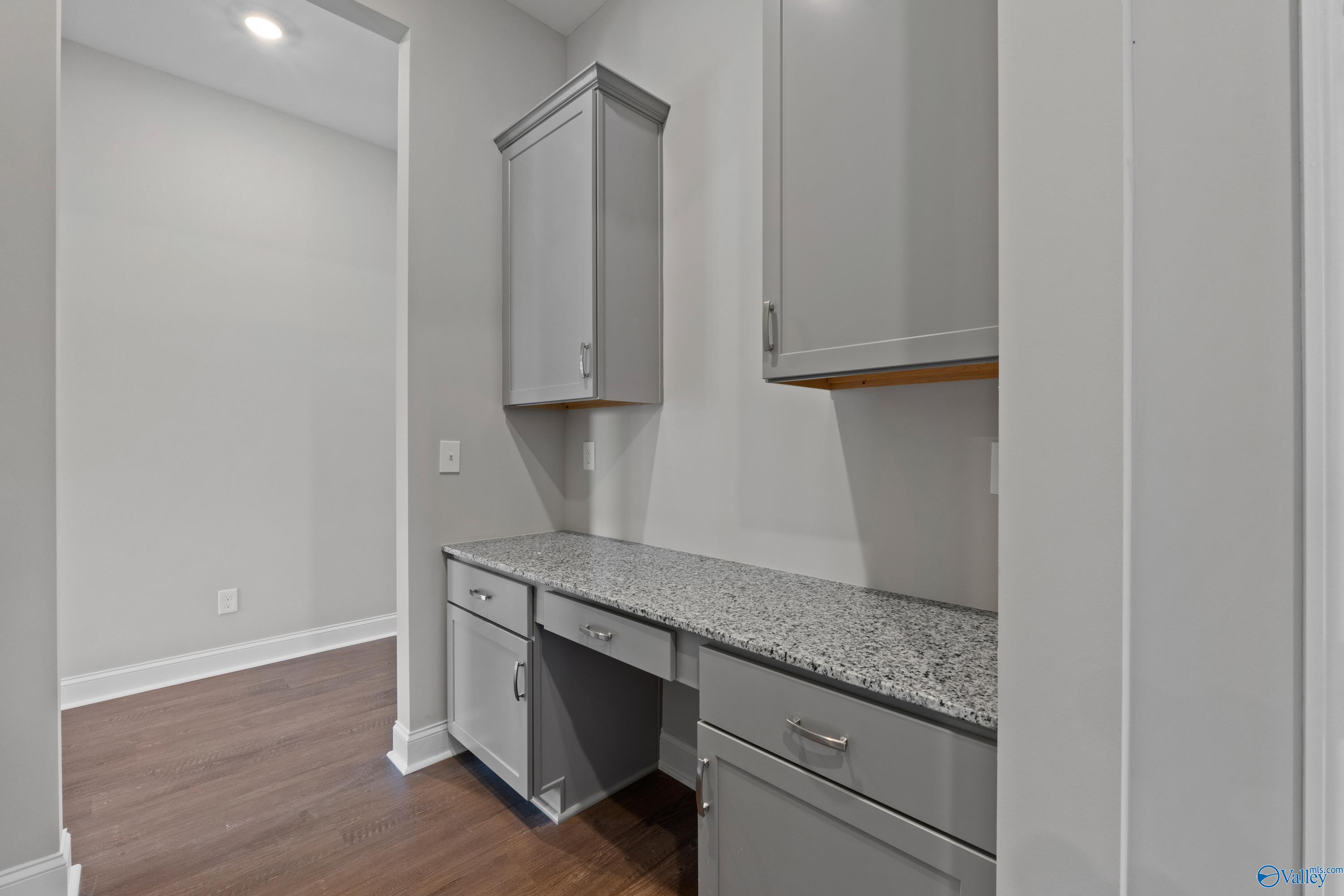 Built-in home office desk with granite countertop and gray cabinets in The Arcadia B floor plan, Riverton Preserve, Huntsville