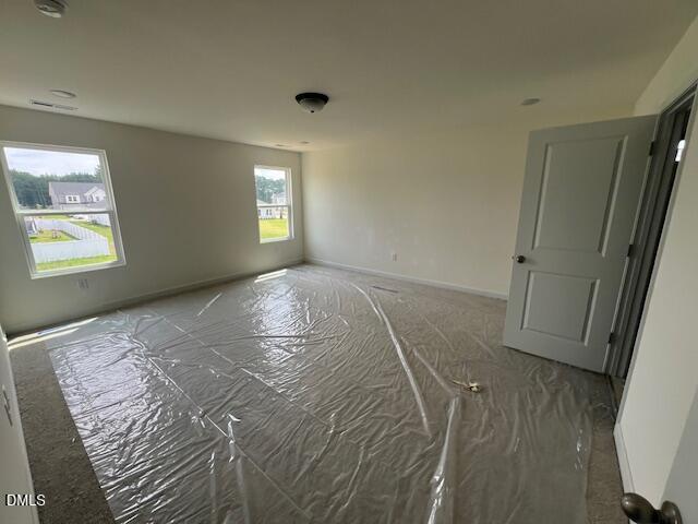 Spacious secondary bedroom with carpet protection in The Hickory II B floor plan at Retreat at North Main, Lillington, NC.
