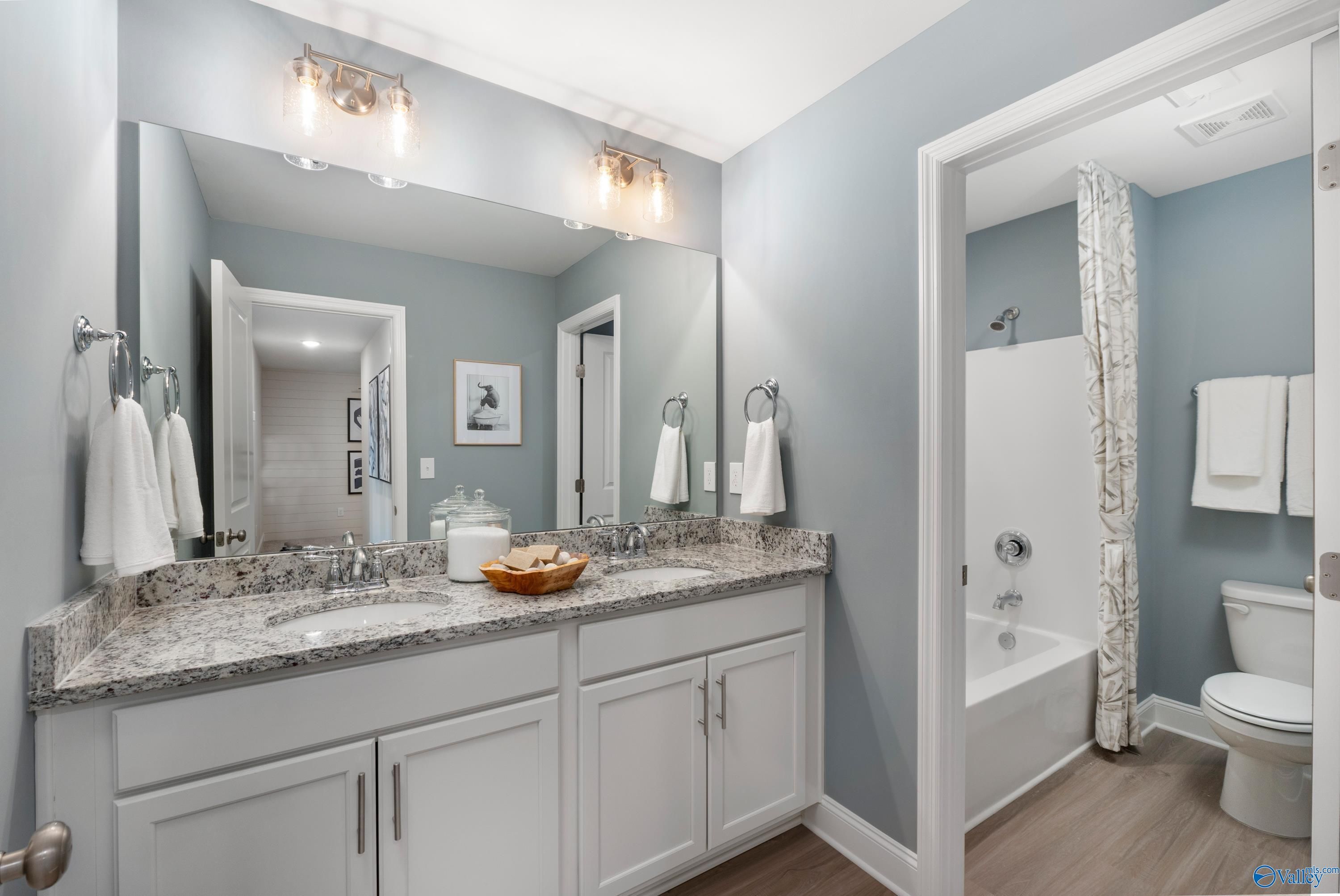 Modern master bathroom with double granite vanity, subway tile shower, soaking tub in Davidson Homes The Camden, Huntsville AL