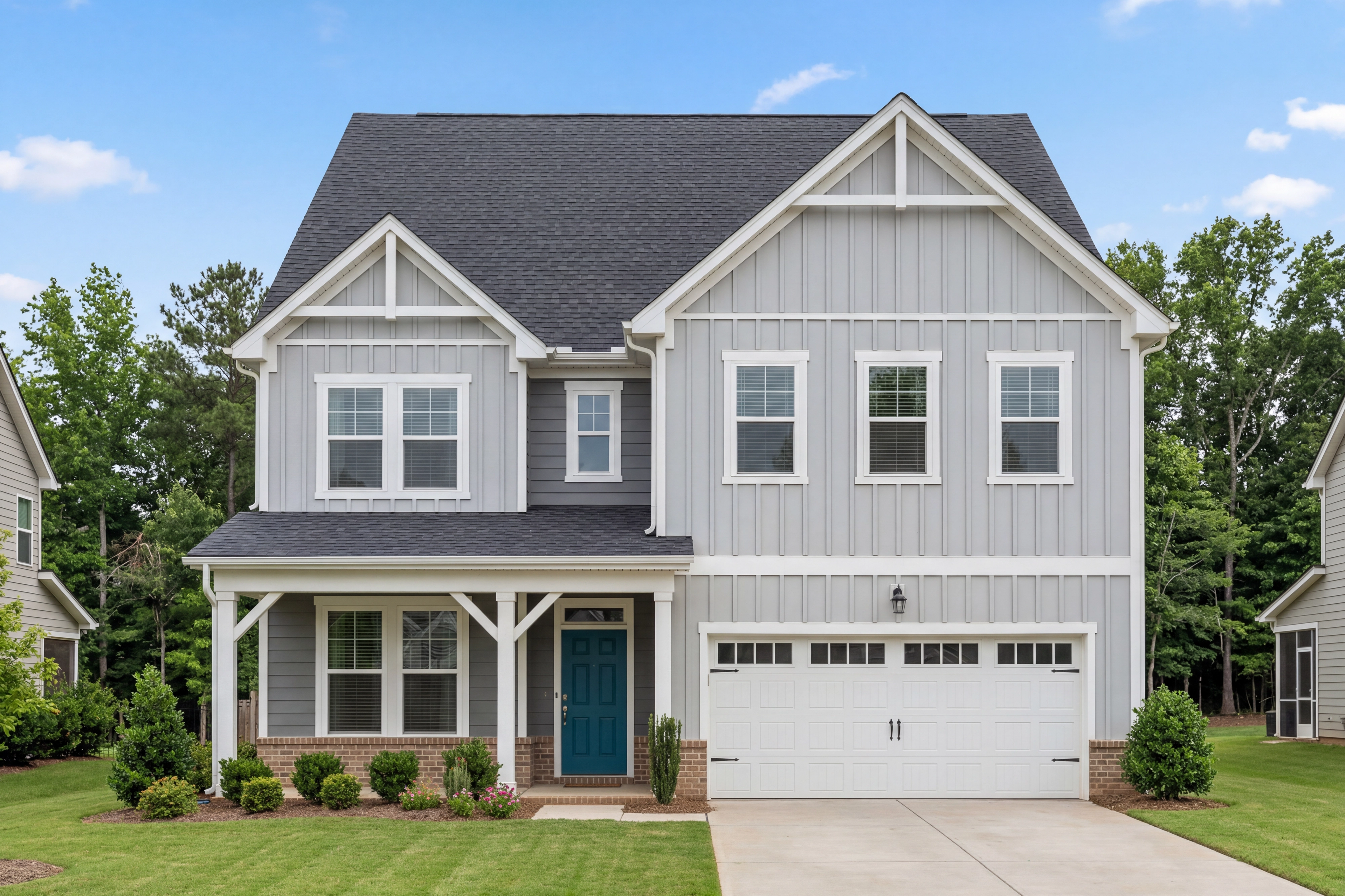 Aspen B two-story craftsman elevation by Davidson Homes: gray board-and-batten siding, black gable roof, turquoise door, two-car garage