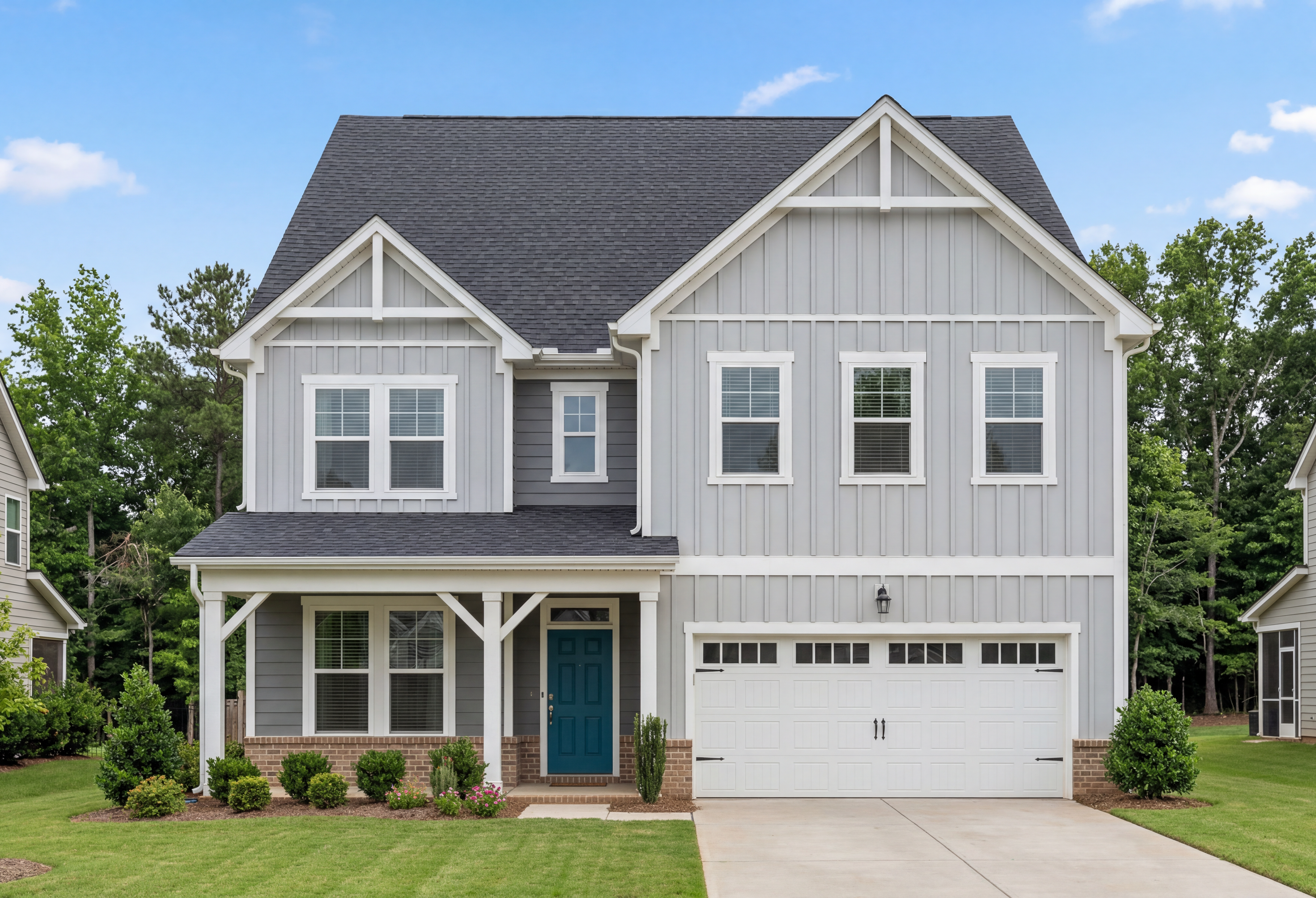 Aspen B two-story craftsman elevation by Davidson Homes: gray board-and-batten siding, black gable roof, turquoise door, two-car garage