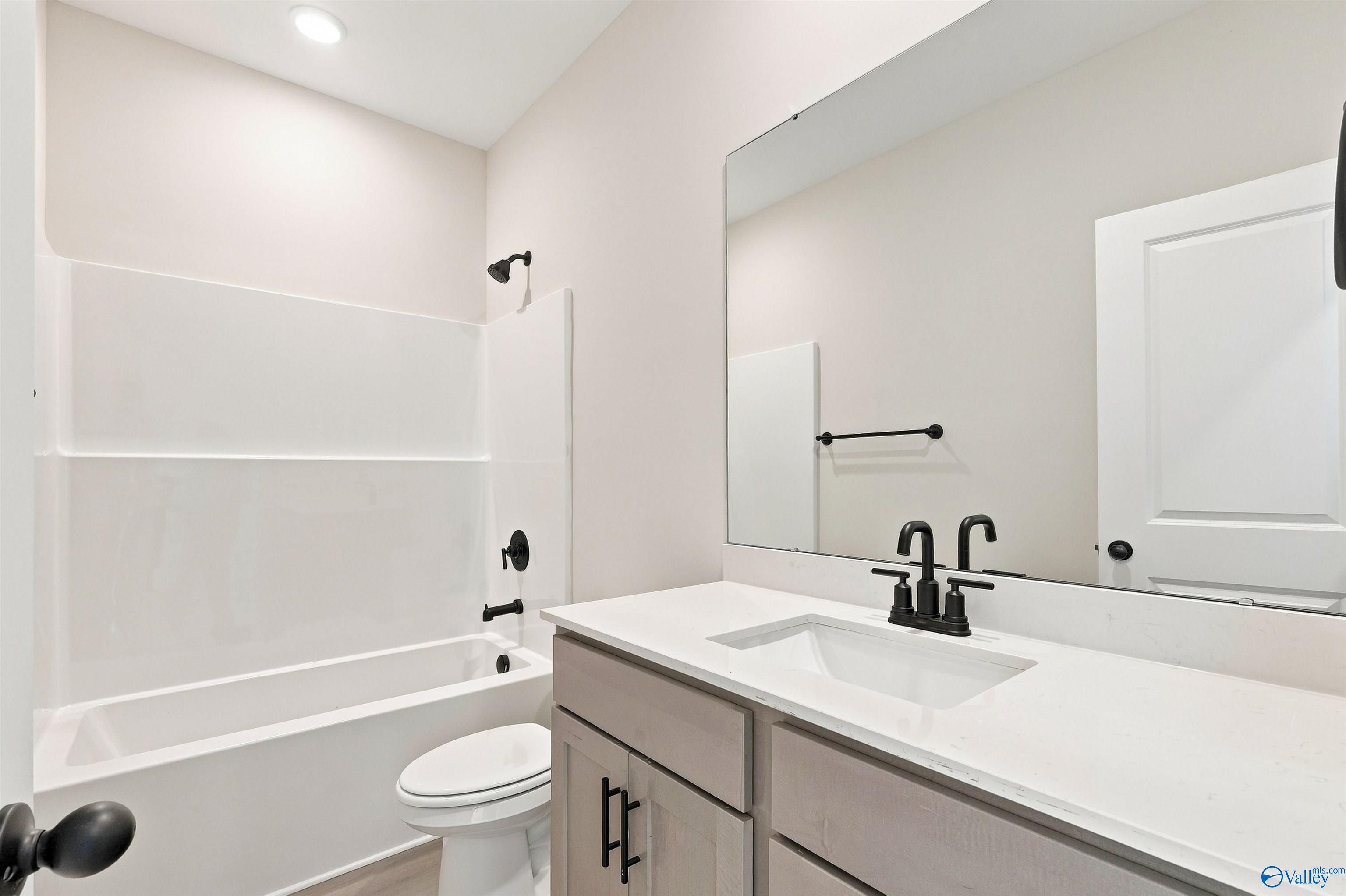 Modern bathroom with tub-shower combo and vanity in The Daphne floor plan by Davidson Homes in Spragins Cove, Huntsville.